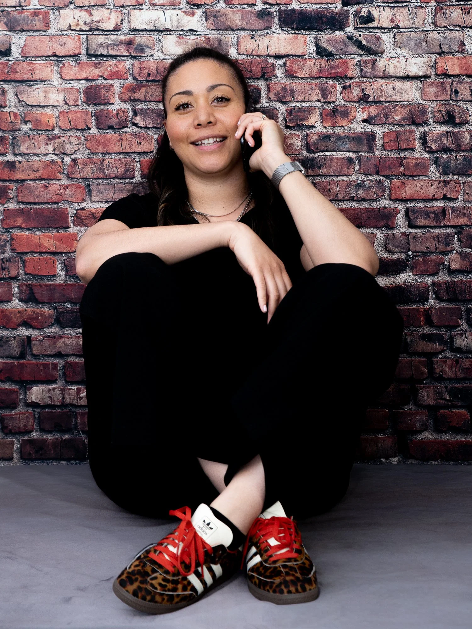 Shannon O'Brien sitting relaxed smiling on the phone to speaking on a discovery call