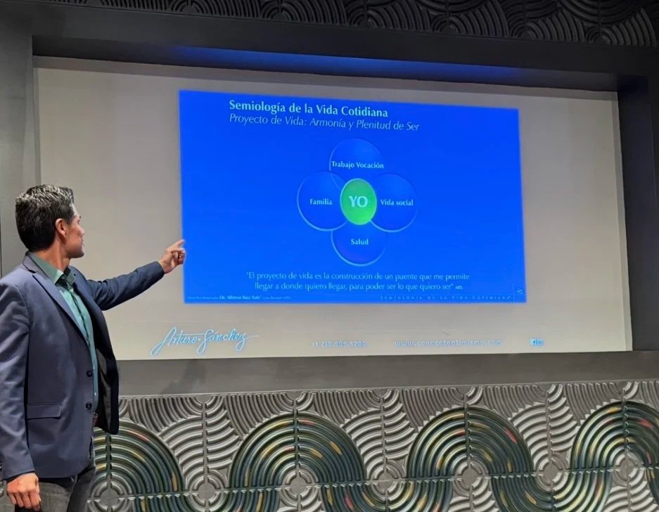 Arturo Sánchez Conócete a ti mismo.com presenta una diapositiva sobre la Semiología de la Vida Cotidiana y el conocimiento de ti mismo crucial para la vida, en una  sala de conferencias.