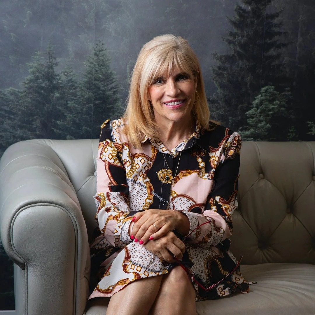 Dr. Shari DeClerico-Anderson, Registered Psychologist seated on a couch
