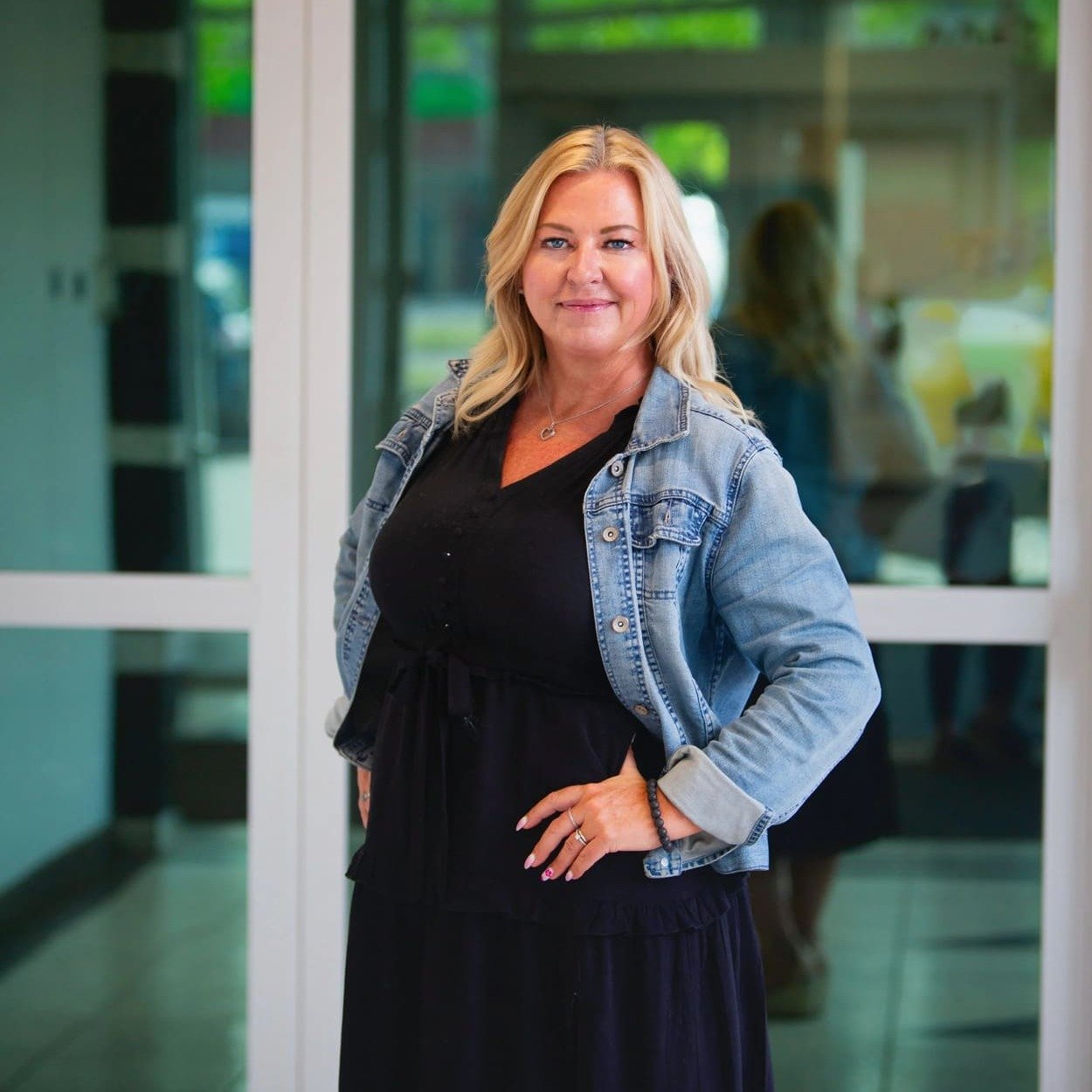 Christy Leeferink, Director at Psychology in the Park, standing in a modern office hallway