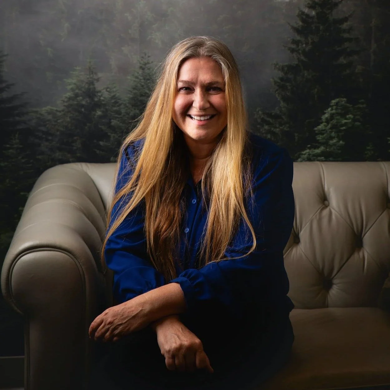 Glory Marie Grant, Registered Provisional Psychologist at Psychology in the Park, seated on a couch