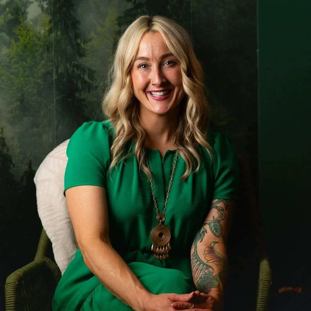 Brandi Booth, Certified Yoga Teacher at Psychology in the Park, seated in a lounge chair