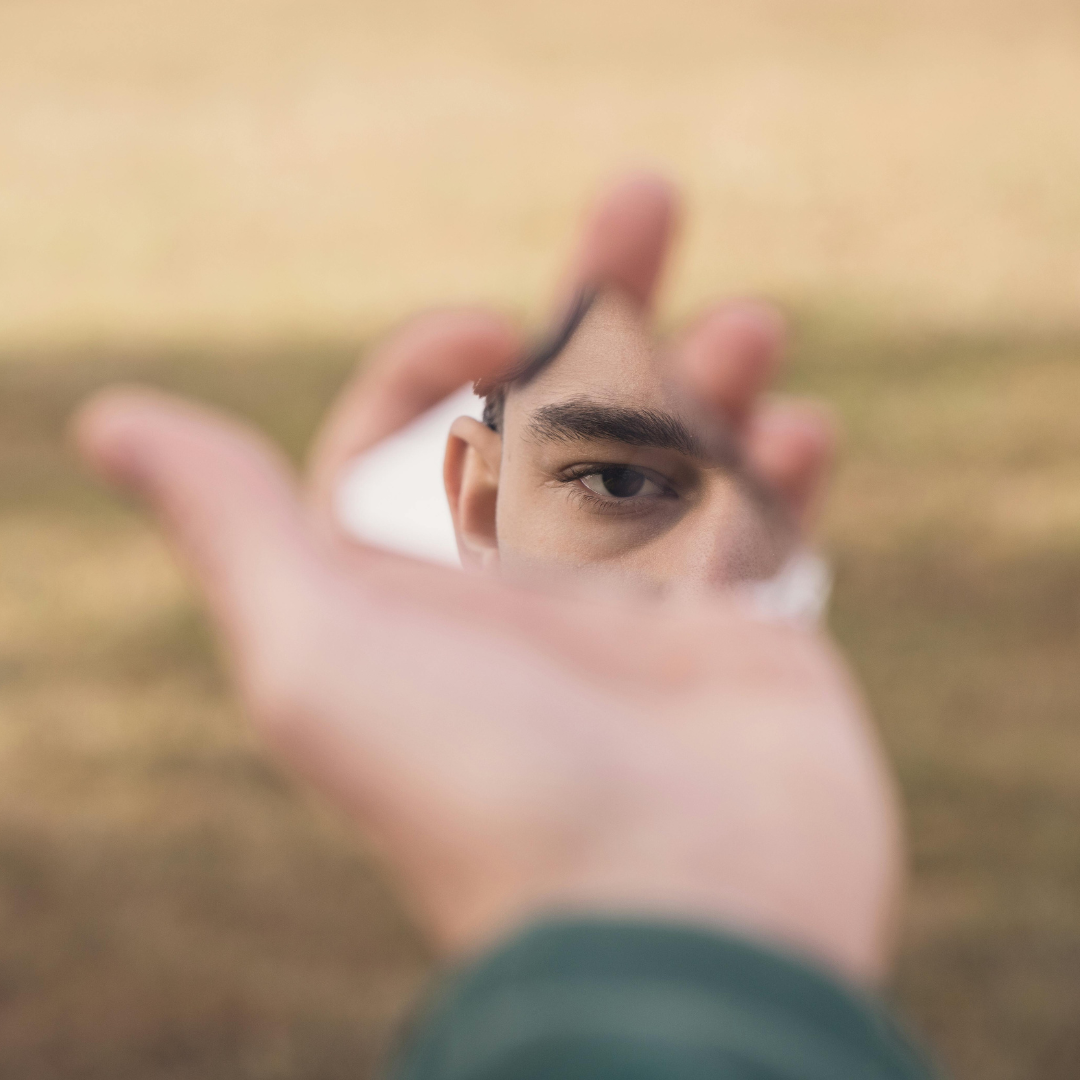 a person holding a mirror up to their face