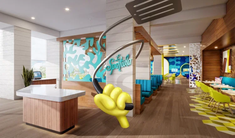 Modern restaurant interior with colorful decor, blue booths, lime green chairs, wooden accents, and a large decorative hand holding a sign that says 'Squalo'.