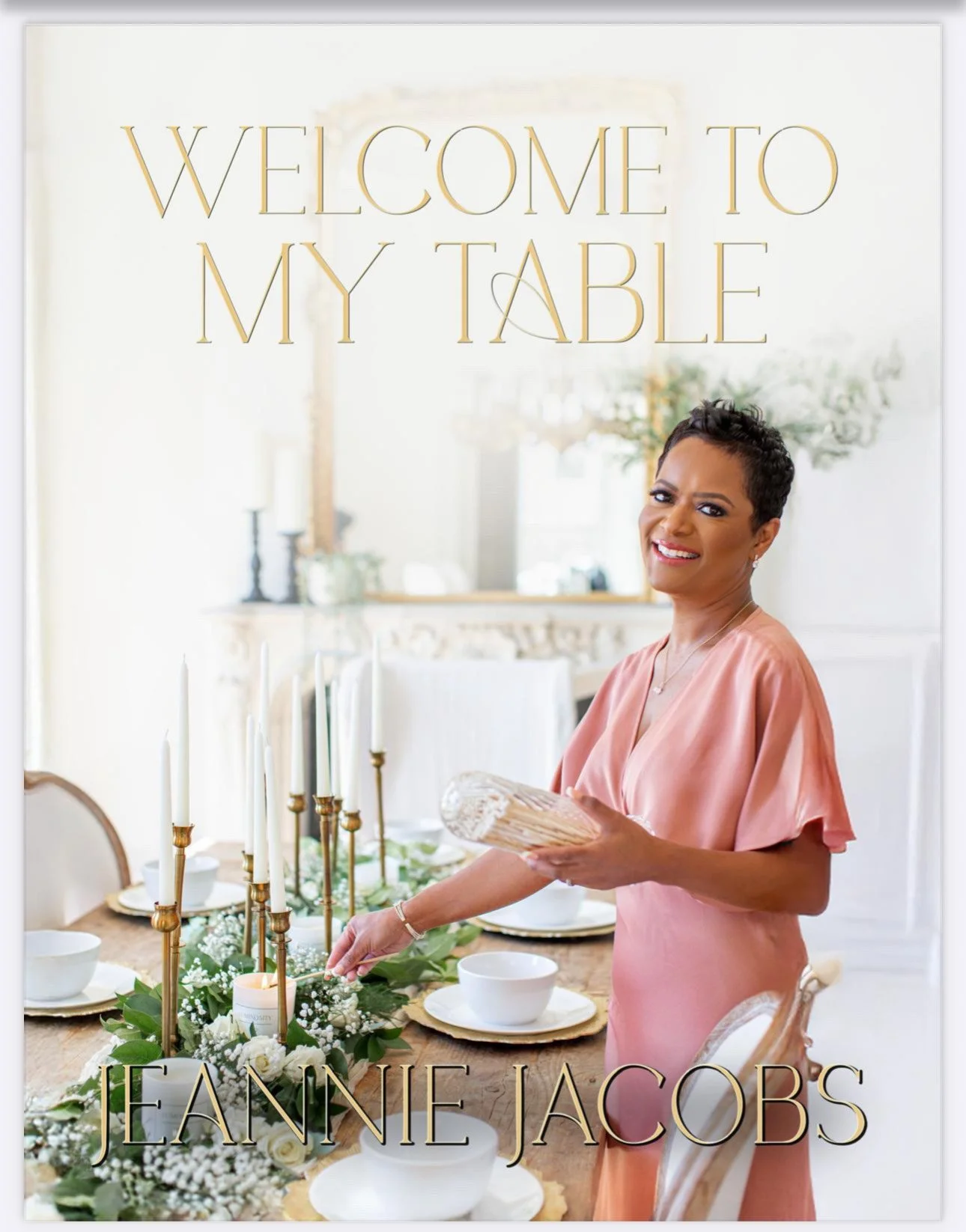 Book cover with a smiling woman in a pink dress setting a dining table with candles and greenery