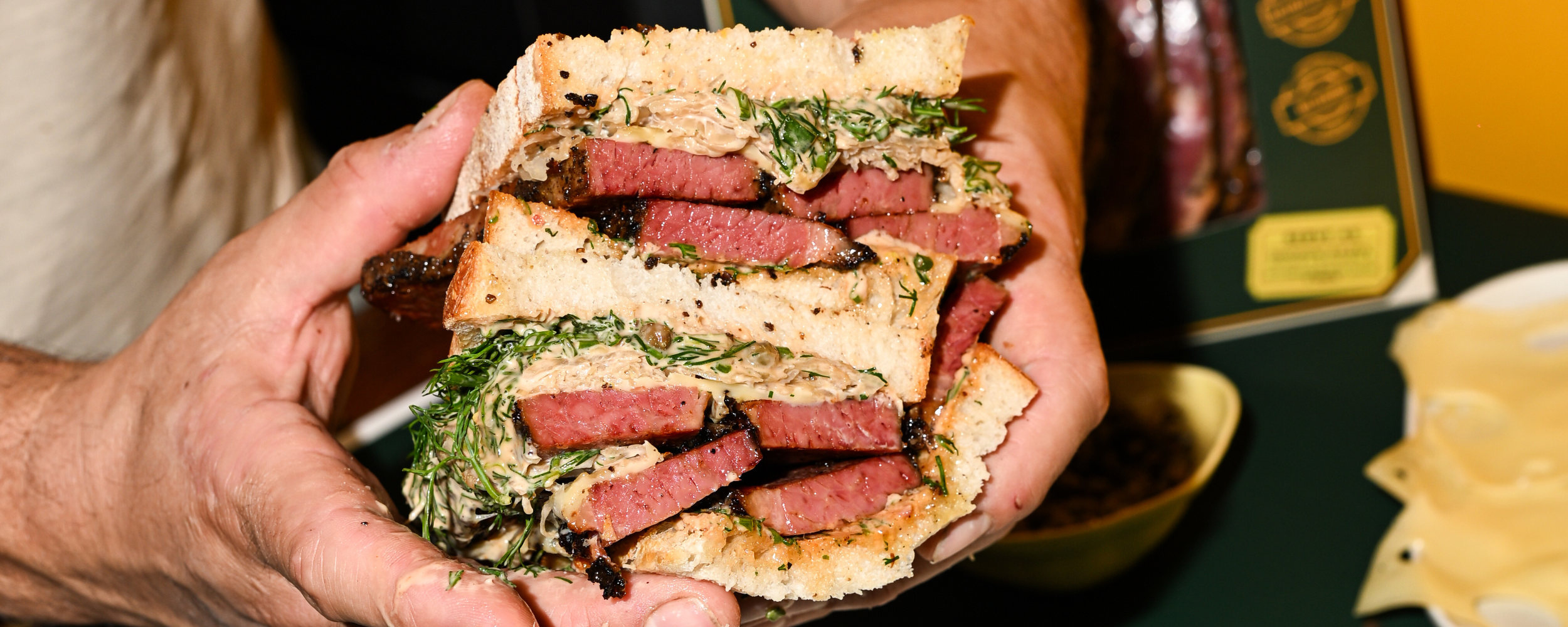 Close-up shot of a Reuben sandwich filled with thick-cut pastrami.