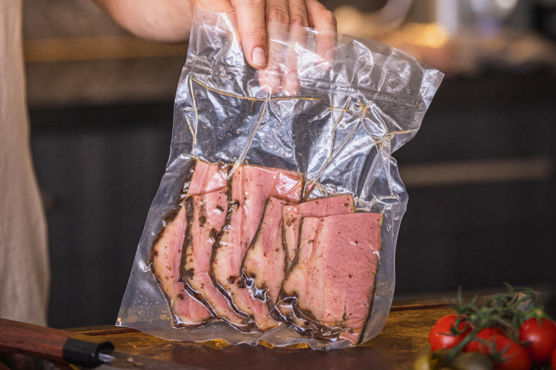 Slices of zaidys thick-cut pastrami in a vacuum-sealed bag.