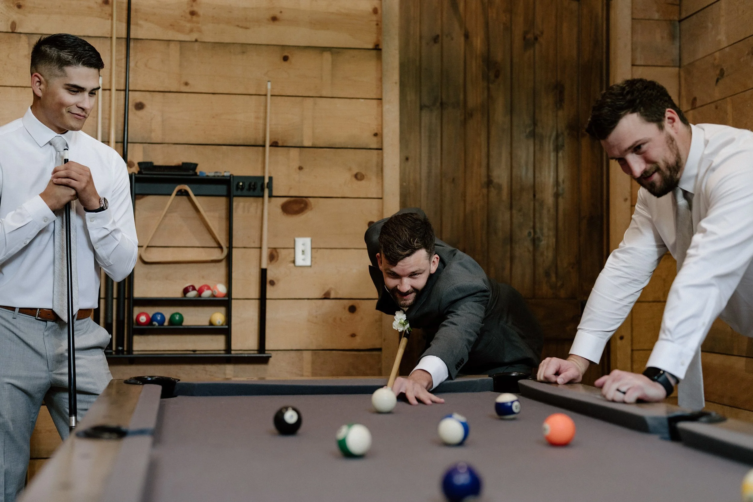texas-hill-country-wedding-groom-playing-pool-with-groomsmen.jpg