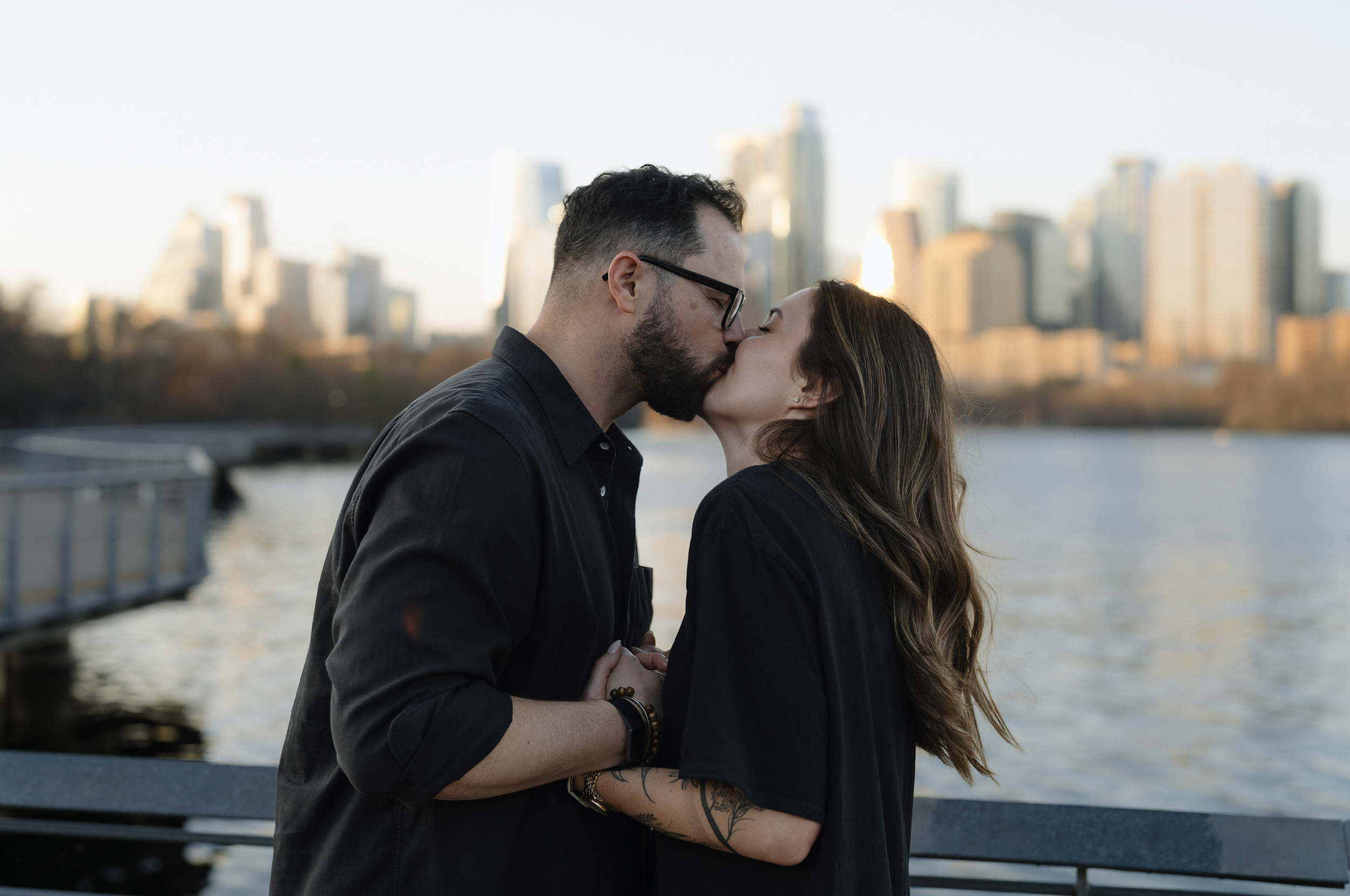 couple shares kiss after proposal on the boardwalk at ladybird lake