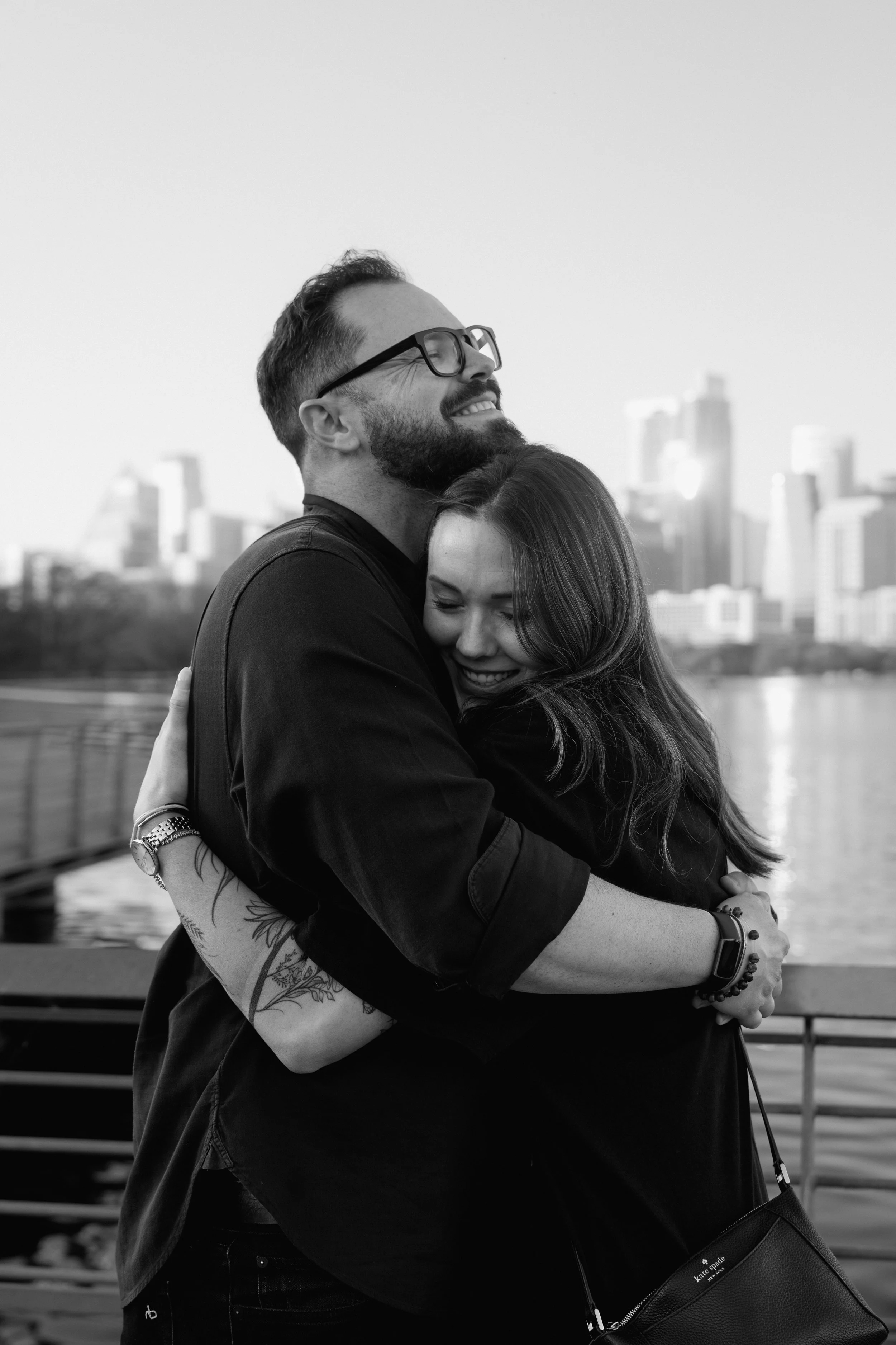 Couple embrace after proposal at Lady Bird Lake in Austin