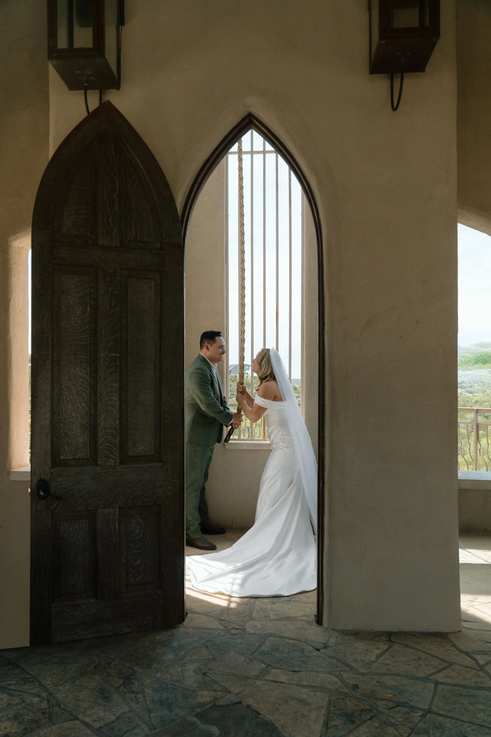 The couple rings the chapel bell together in the tower at Chapel Dulcinea after their ceremony