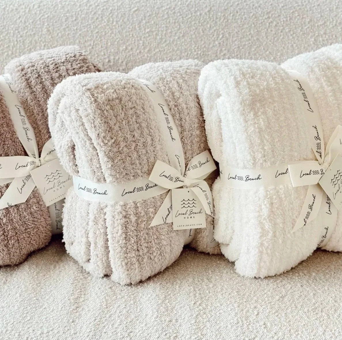 Stack of Local Beach blankets showing several different colors. 