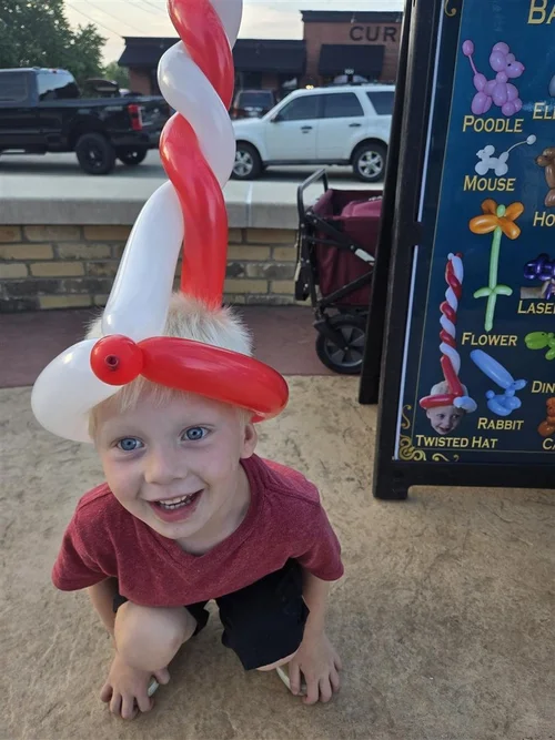 Kid with twisted candy-cane hat
