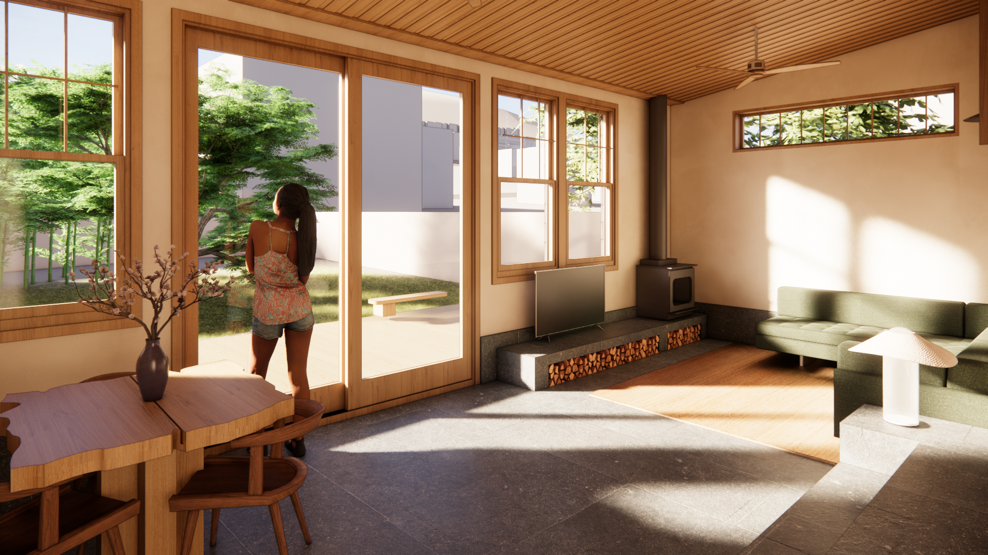Living room with large windows showing a woman looking outside, green trees, and a backyard with outdoor furniture.