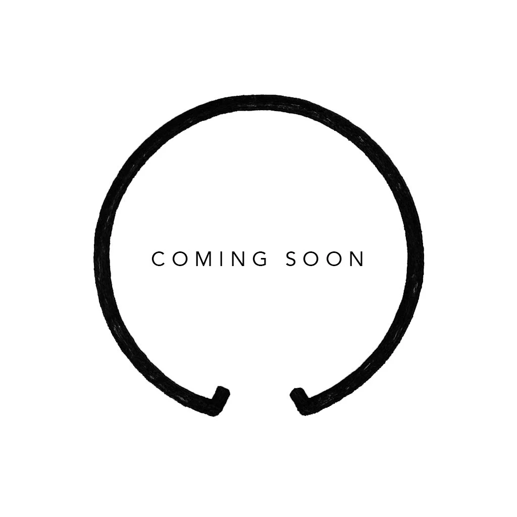 A minimalist design with a black circular stroke and the text 'COMING SOON' inside, on a white background.