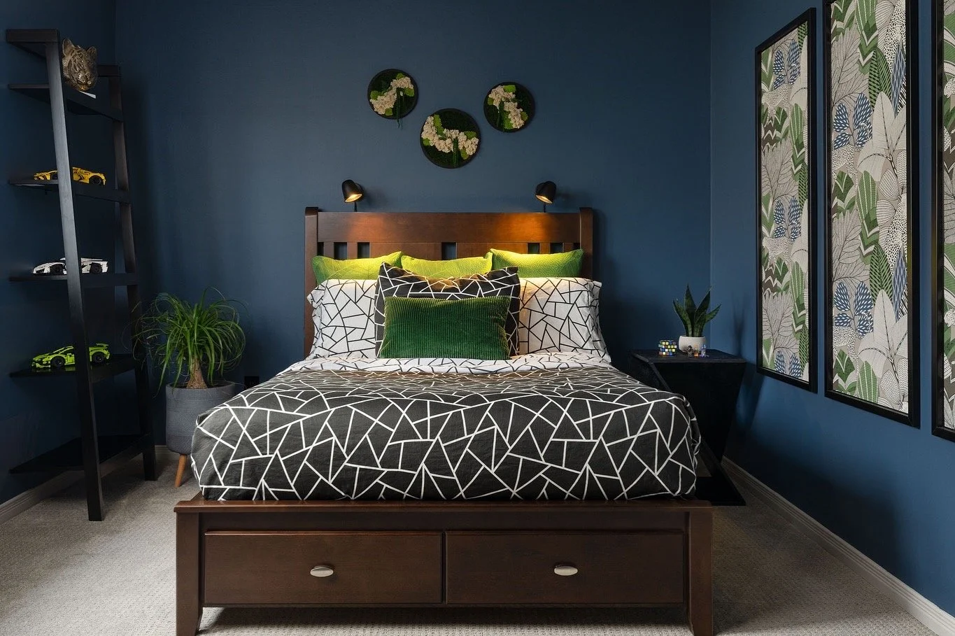 Moody boy's bedroom, with graphic black and white bedding and deep blue walls
