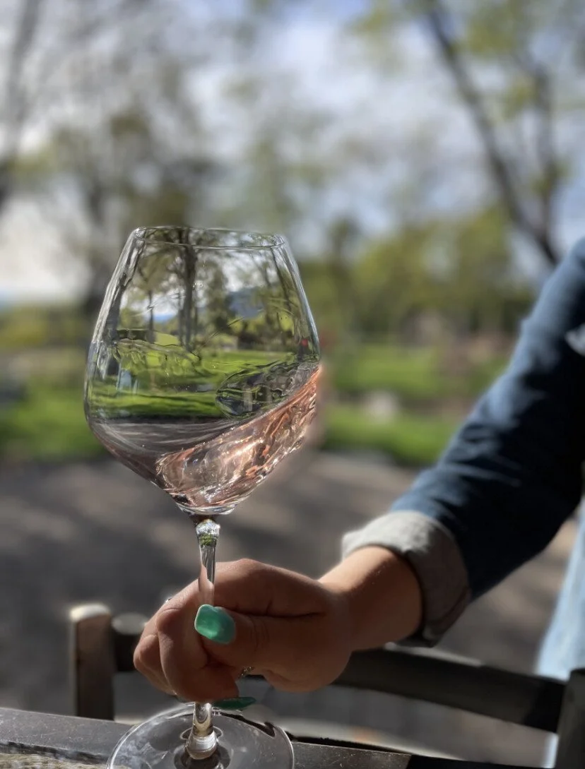 Guest swirling a glass of wine at a romantic getaway weekend.