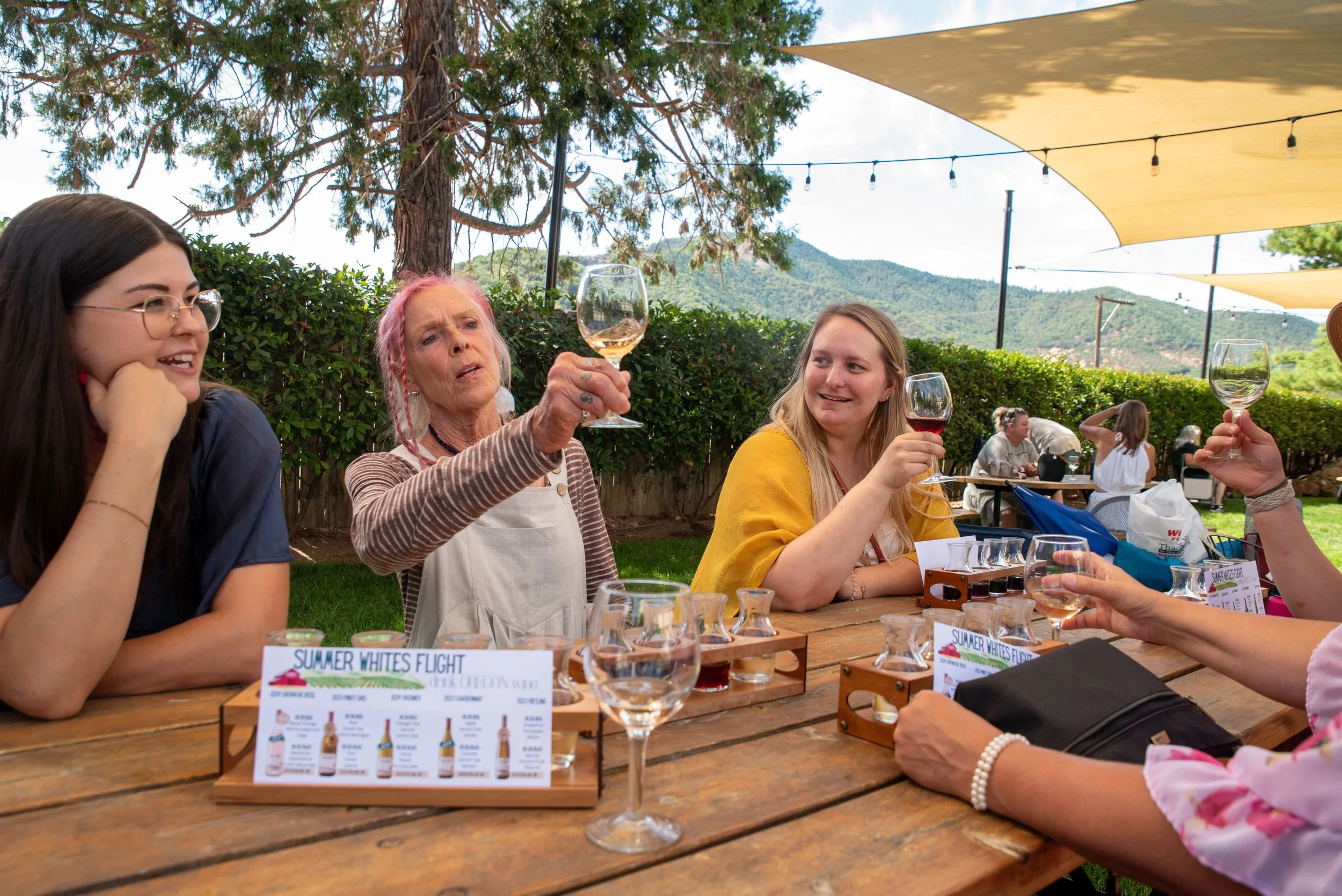 Guests admire wine in a glass while on a Rogue Valley wine tours.