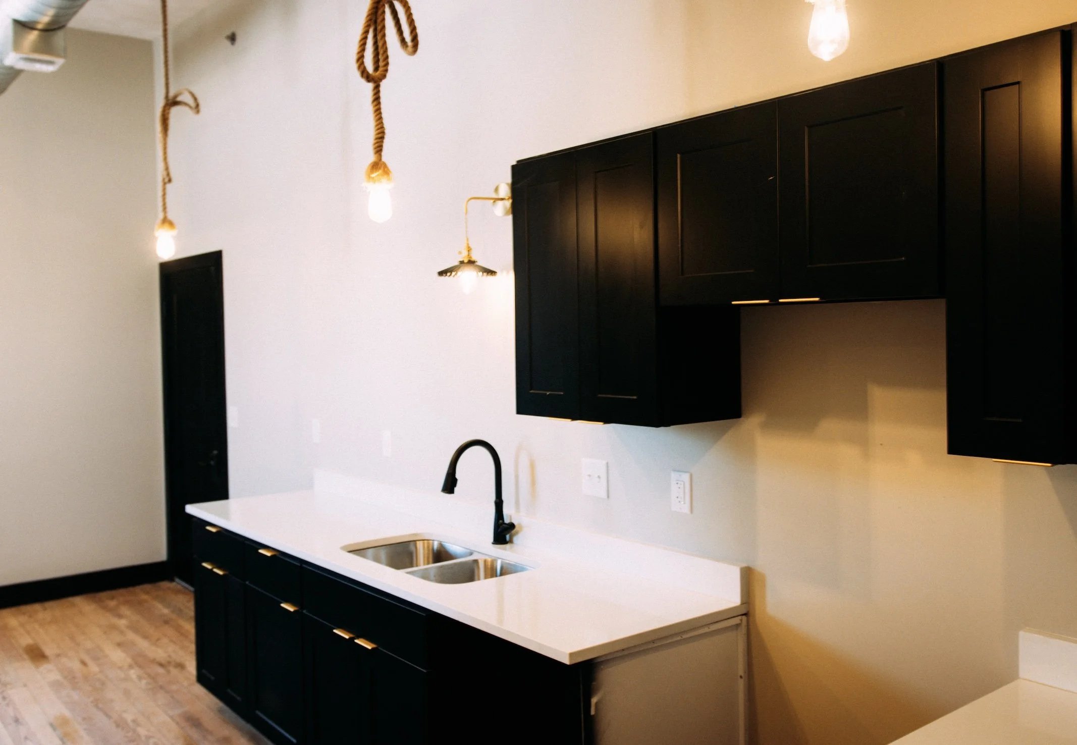 Custom Apartment Renovation |Black Kitchen Cabinets with Gold accents