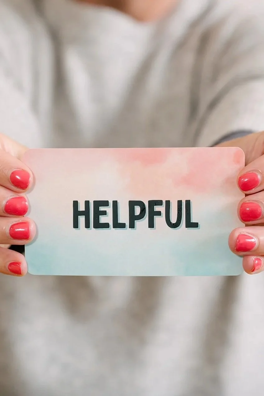 Woman holding a card with the word ‘Helpful'
