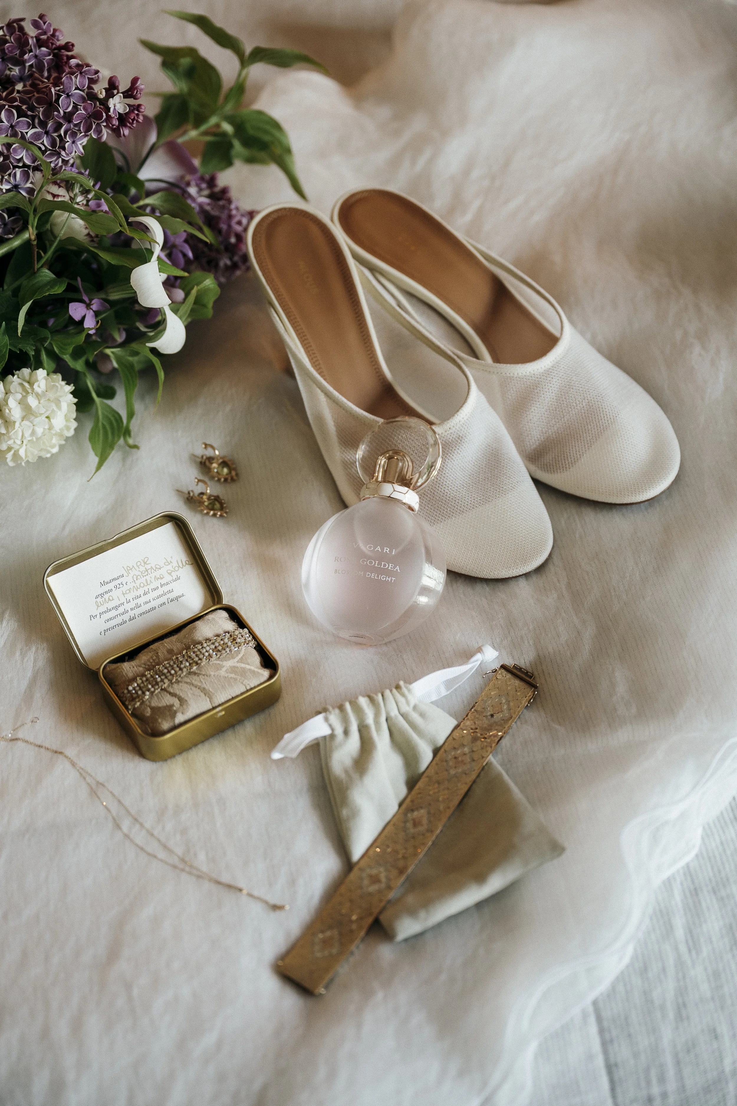 Lace bridal slippers styled on the bed in the Miner’s Cottage.