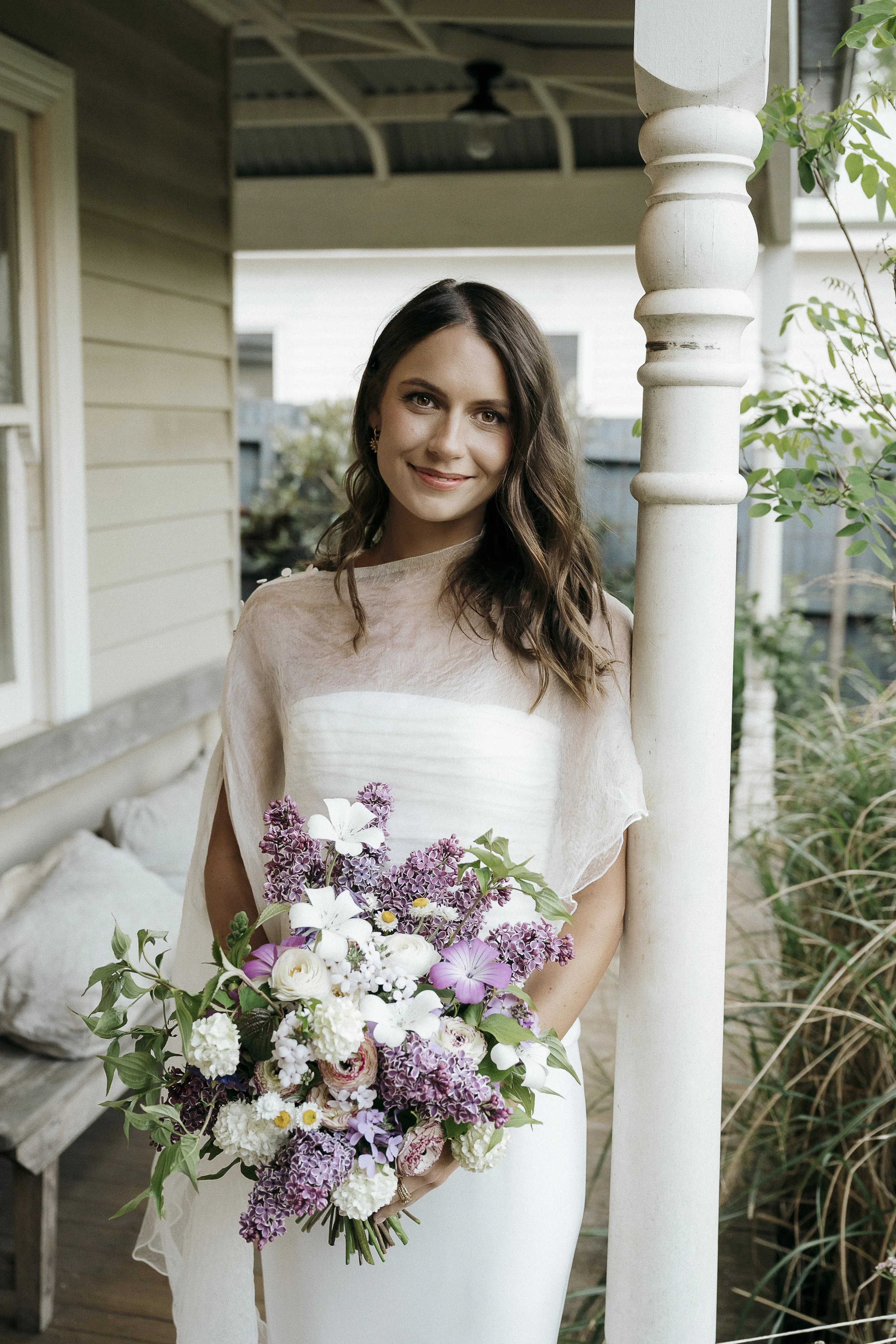 portrait of bride on front verandah holding bouquet of local micro farm flowers