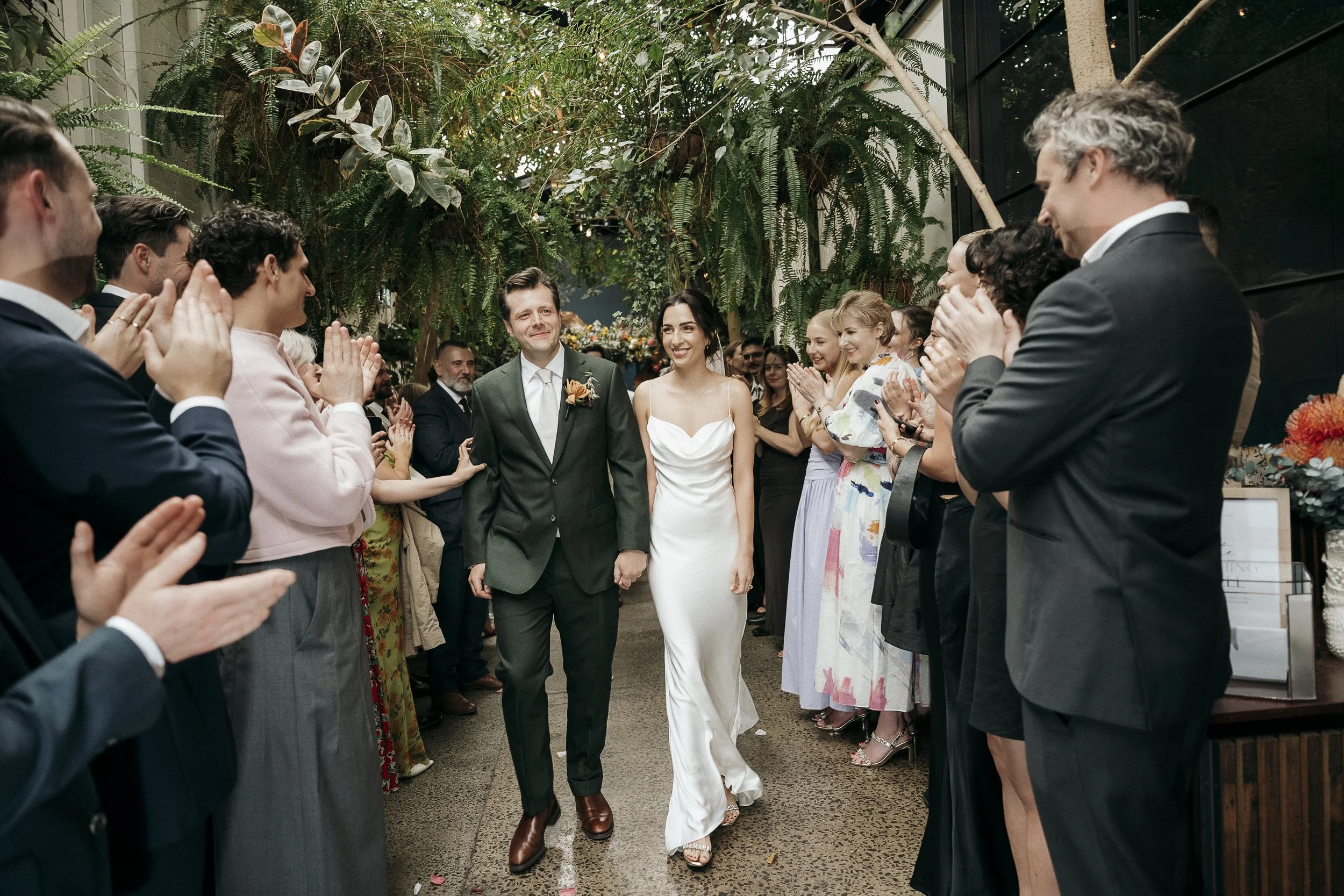 Couple walking hand-in-hand through the venue