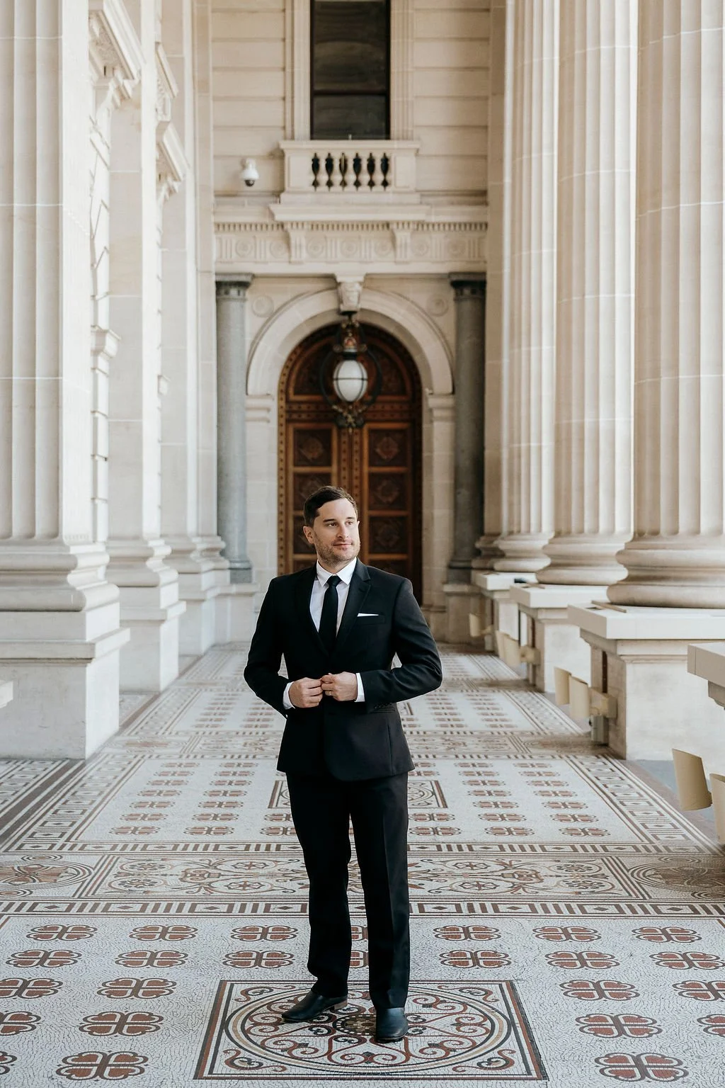  Groom framed by arched doorway at Parliament House Melbourne  