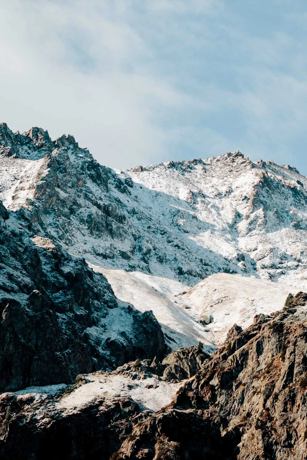 Snow-covered mountains under a blue sky.