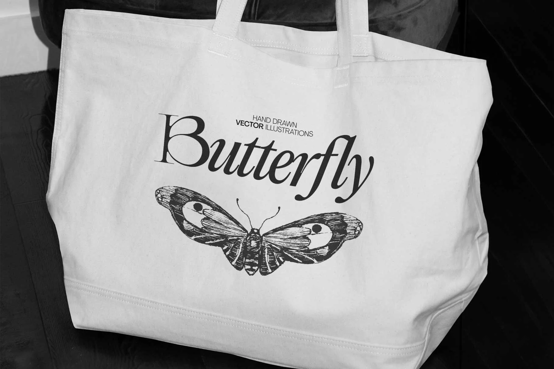 White tote bag with a butterfly illustration and the word "Butterfly" printed on it.