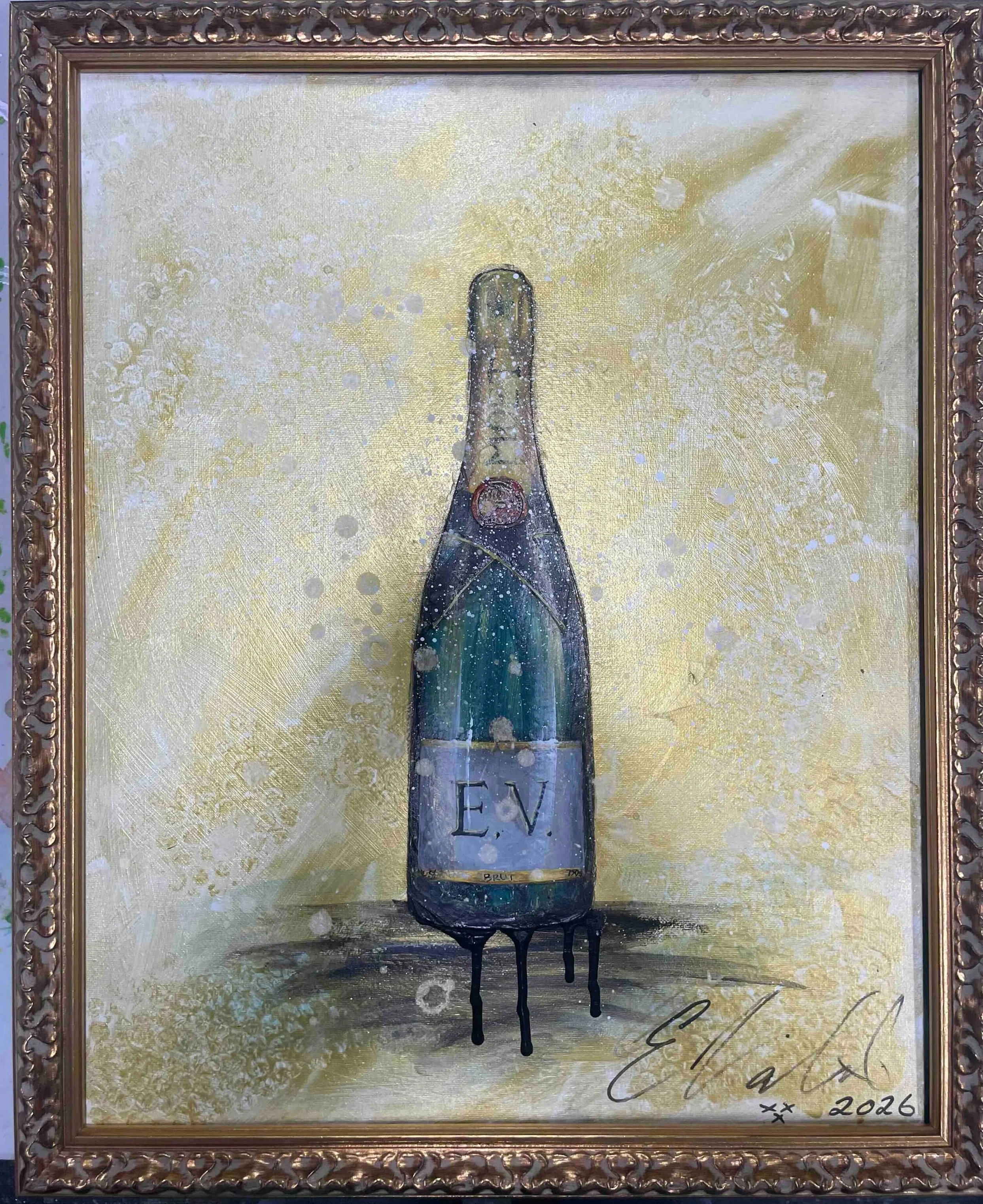 A framed painting of a champagne bottle with the initials 'E.V.' on its label, set against a gold background with splashes and drips of paint, signed and dated 2026.