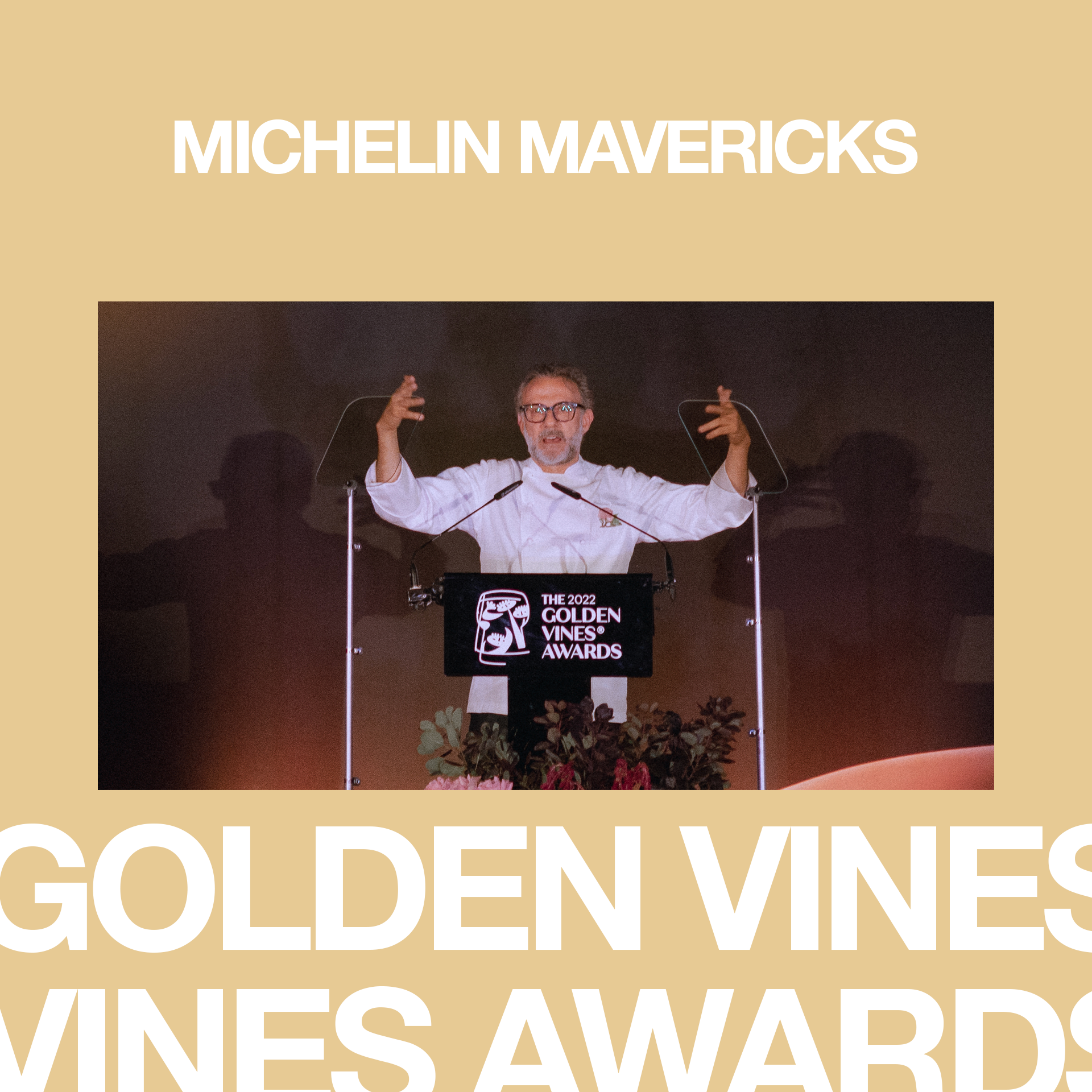 Man at podium speaking at Golden Vines Awards, with a backdrop displaying the 2022 Golden Vines Awards logo.