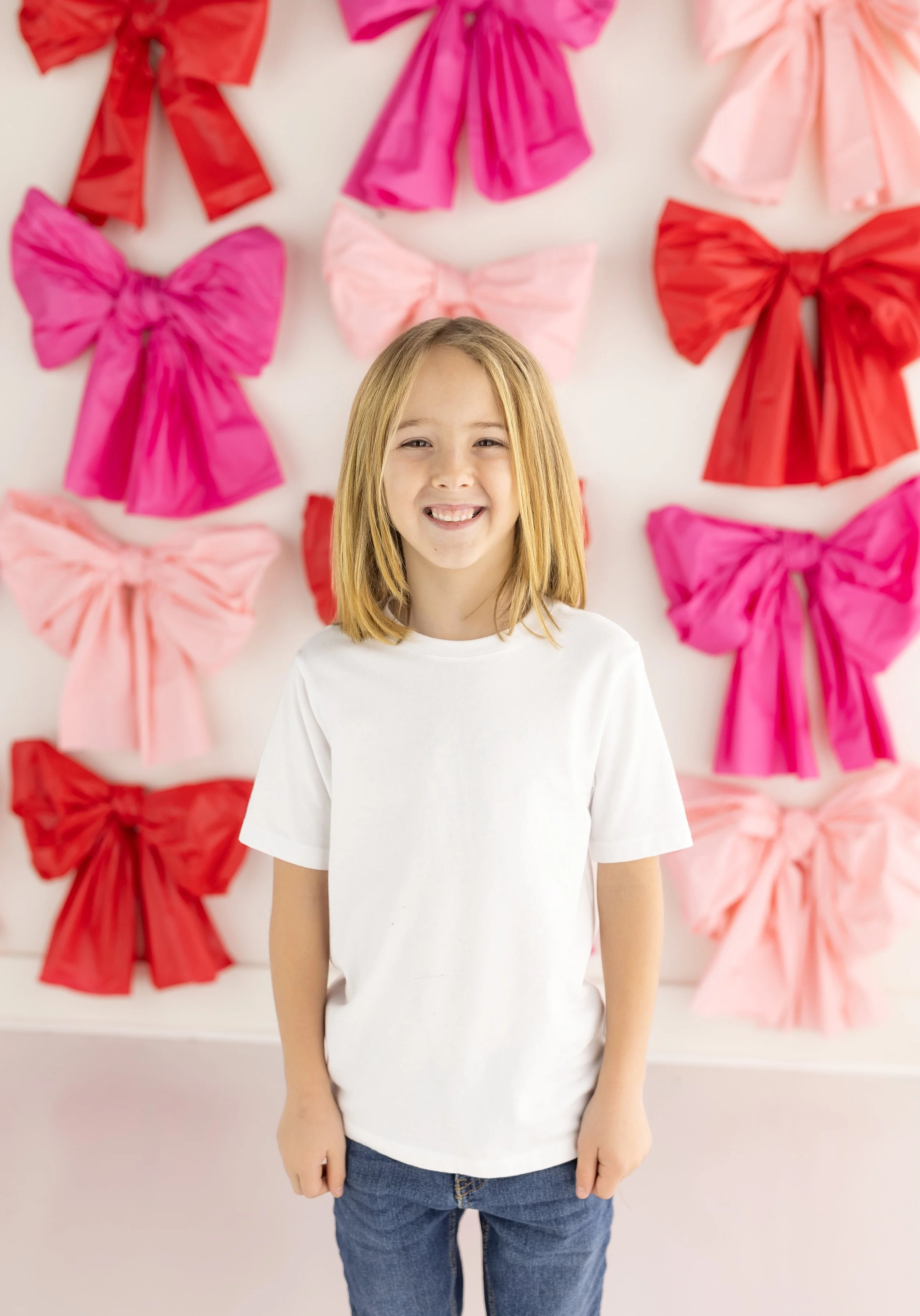 Northwest Arkansas Valentines Minis Photography bow valentines backdrop Farmington, Arkansas NWA boy wearing white shirt and jeans