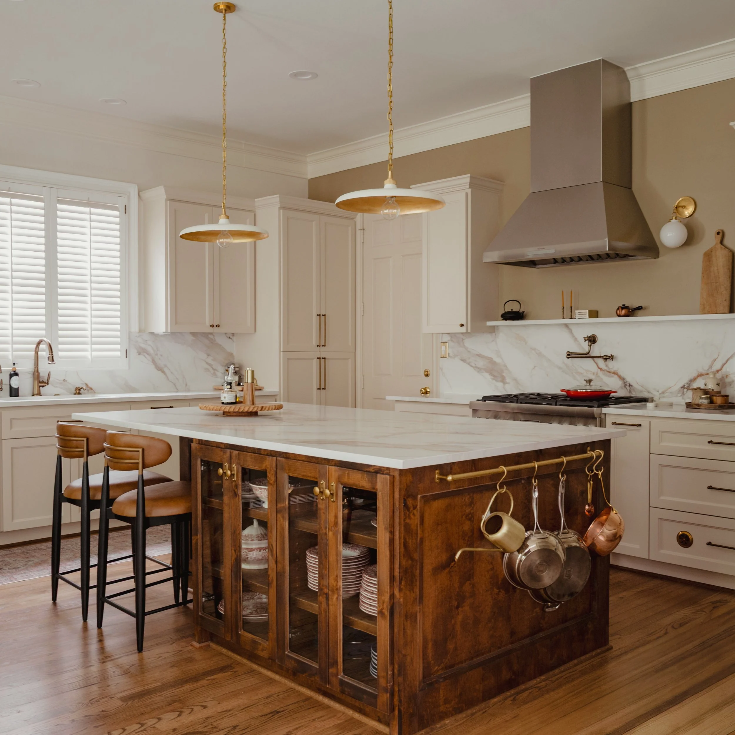 A SPACE MEANT TO BE LIVED IN. 

A timeless English country kitchen inspired by the warmth and character of traditional British homes, shaped through rich walnut tones, soft neutral cabinetry, classic shaker detailing, and aged brass accents. Designed