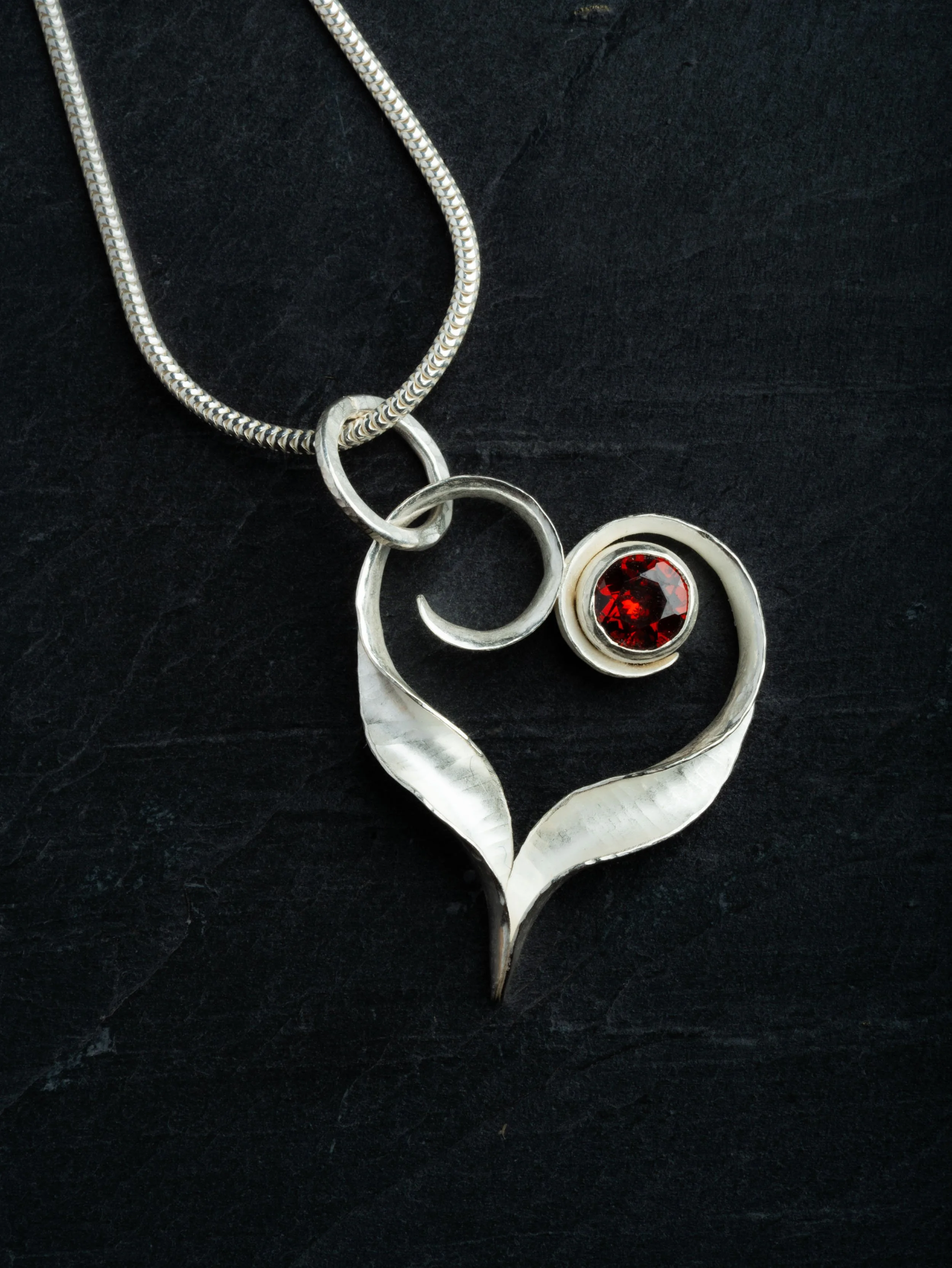 Ripple Heart pendant , asymmetrical, with garnet