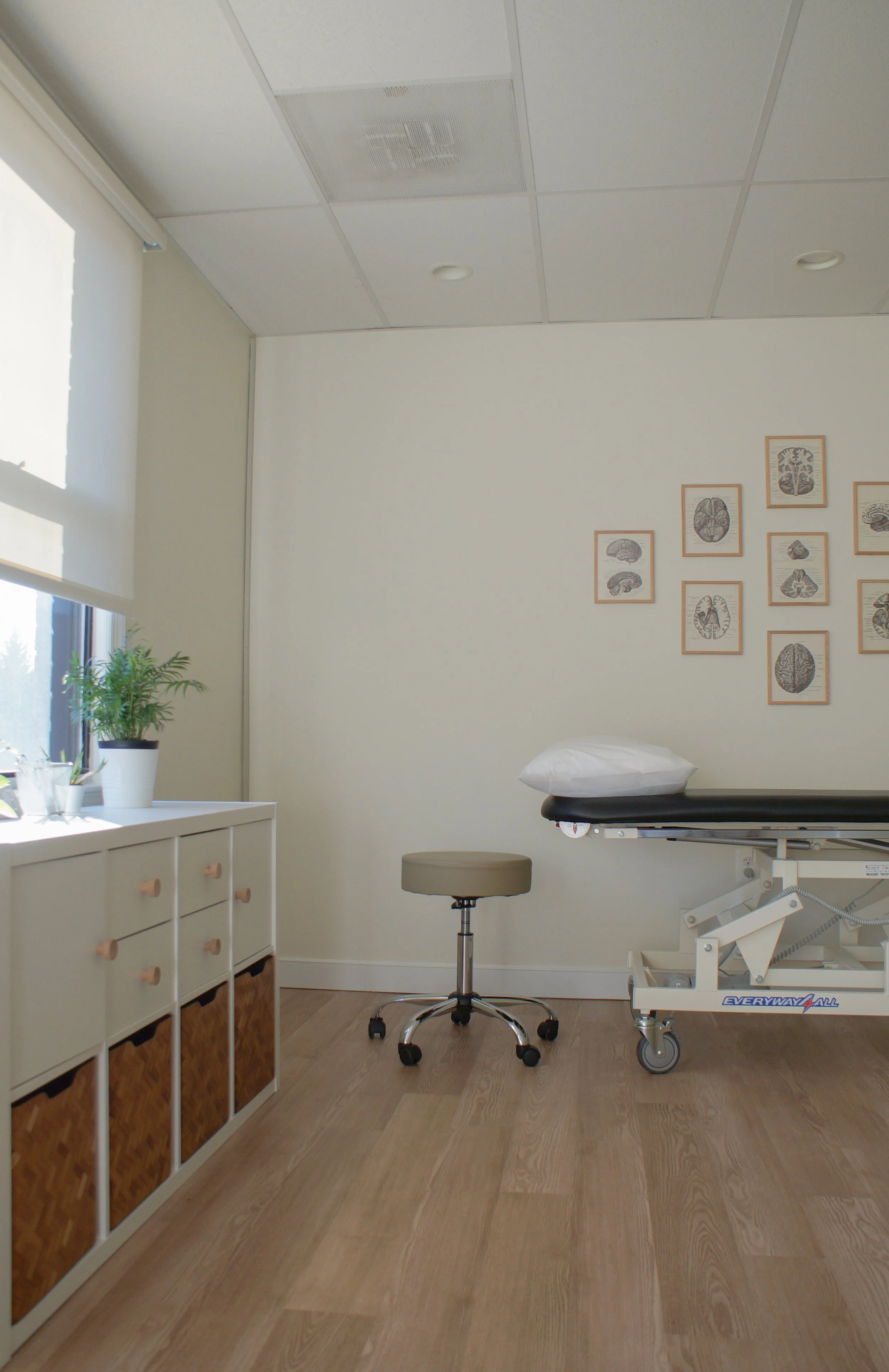 image of clinic with table, stool, and cabniet