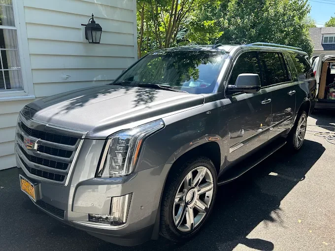 Gray Cadillac Escalade ESV freshly detailed in Rye NY residential driveway