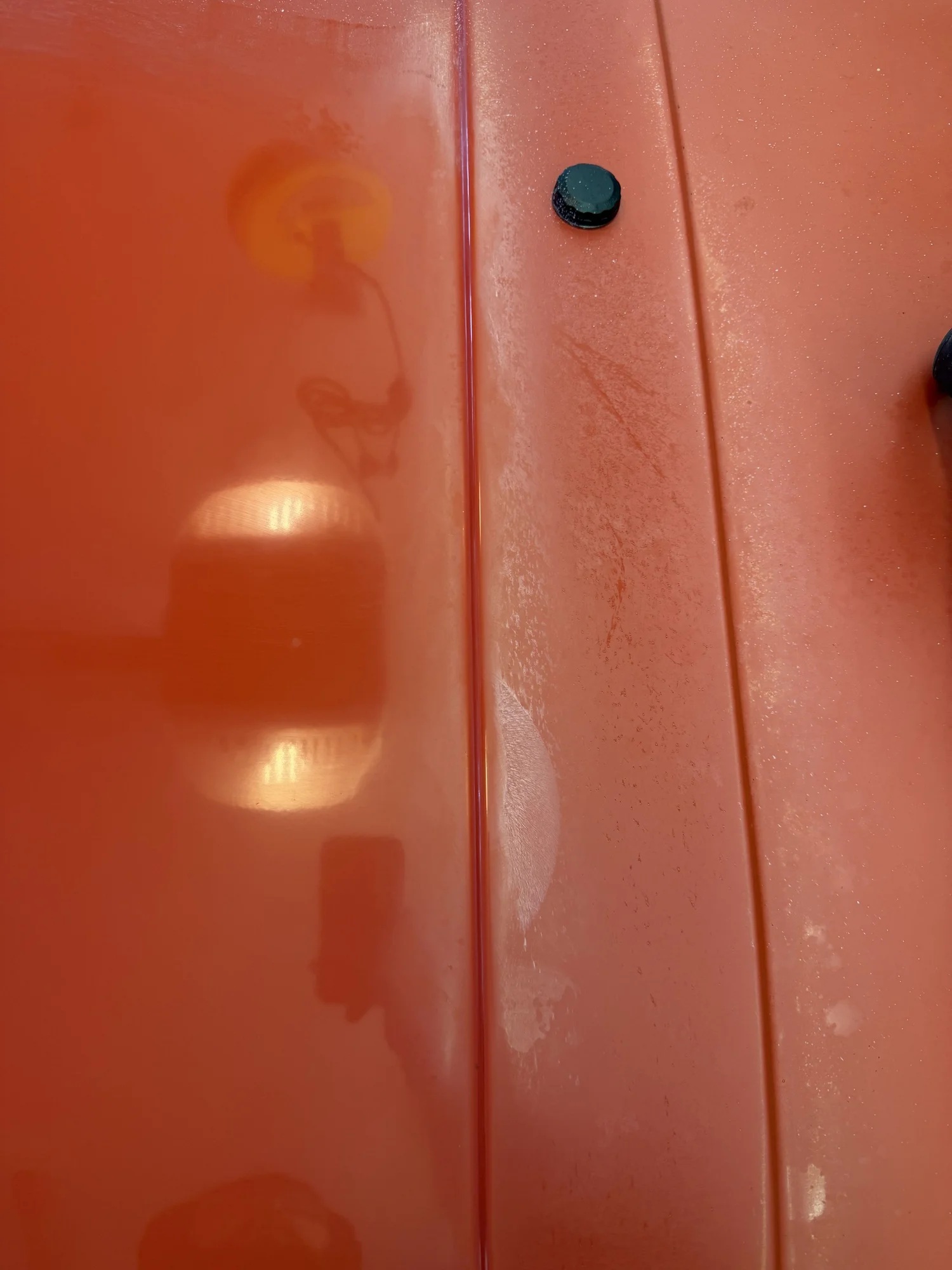 Close-up of clear coat showing surface contamination and fine swirl marks before correction