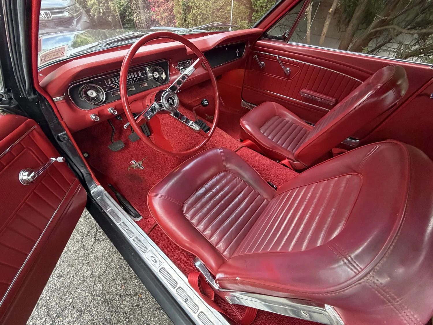 Immaculate red leather interior of classic Mustang after professional detail