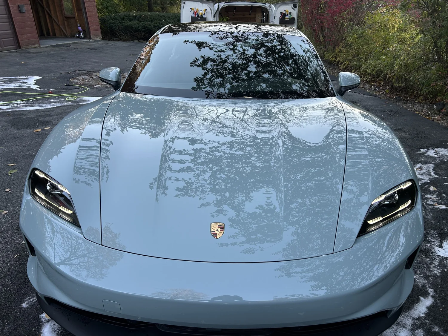 White Porsche Taycan freshly detailed in Old Greenwich CT waterfront setting