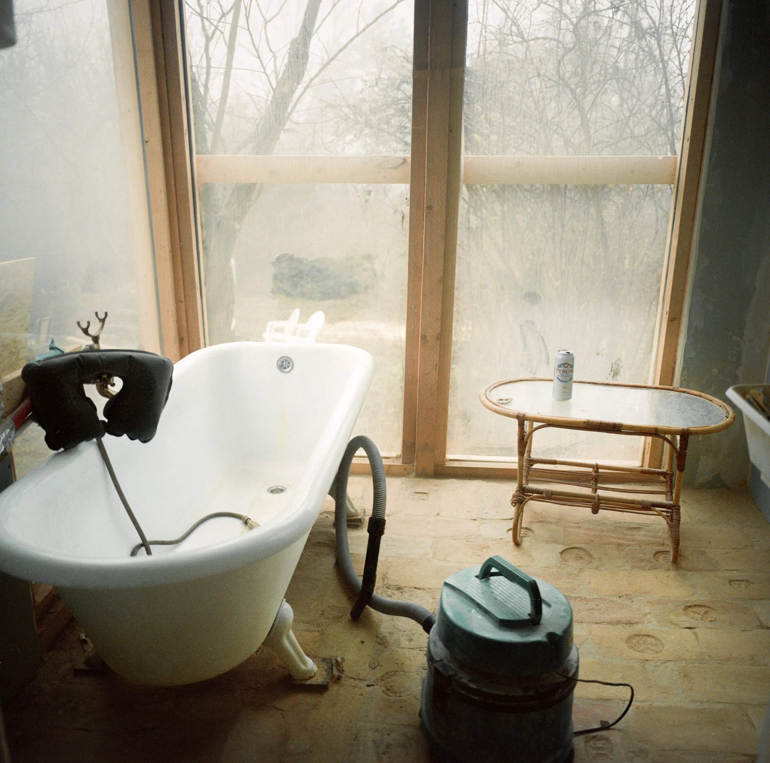 Bathtub beside large window inside home