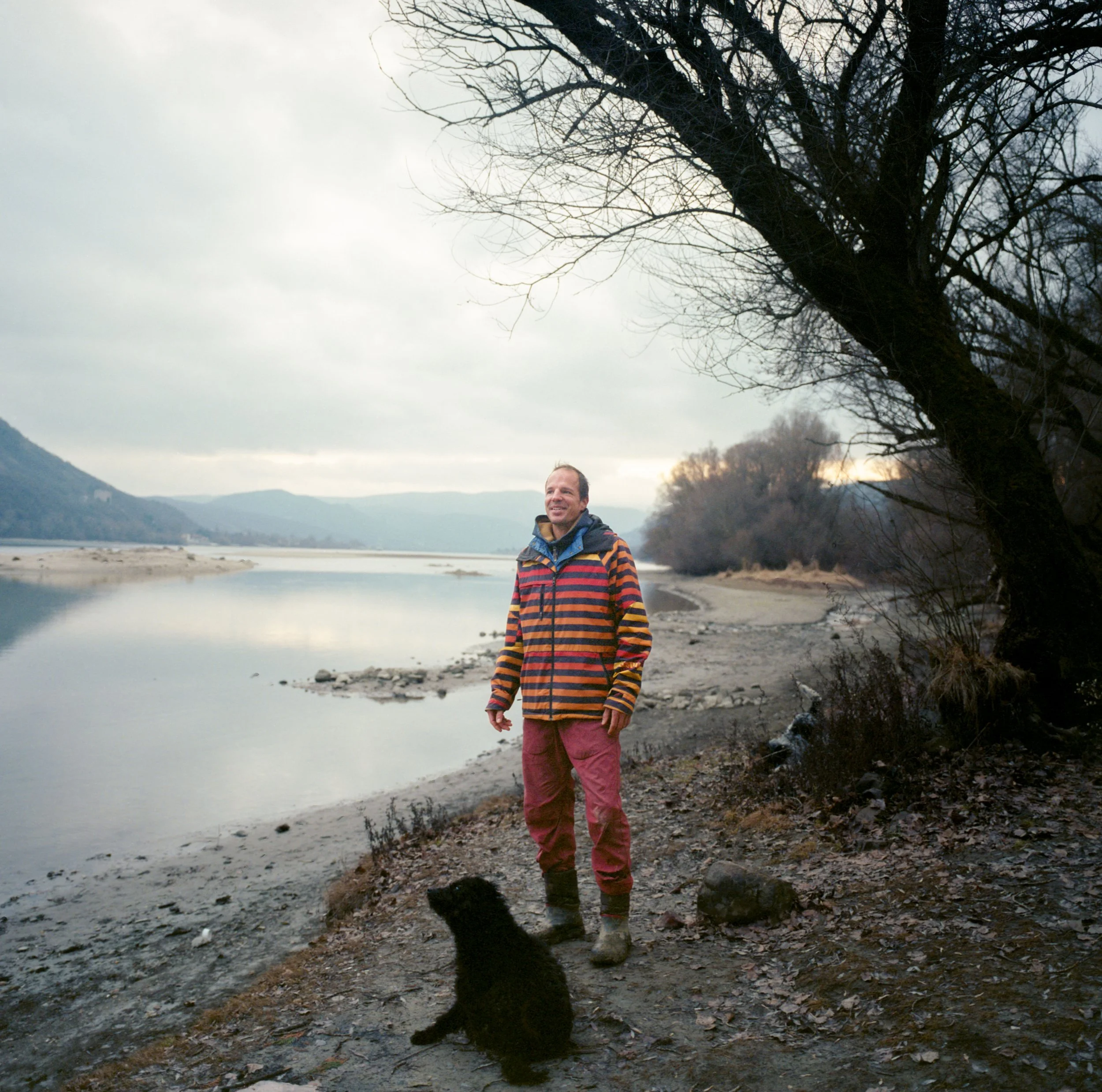 Person standing beside the Danube in striped sweater