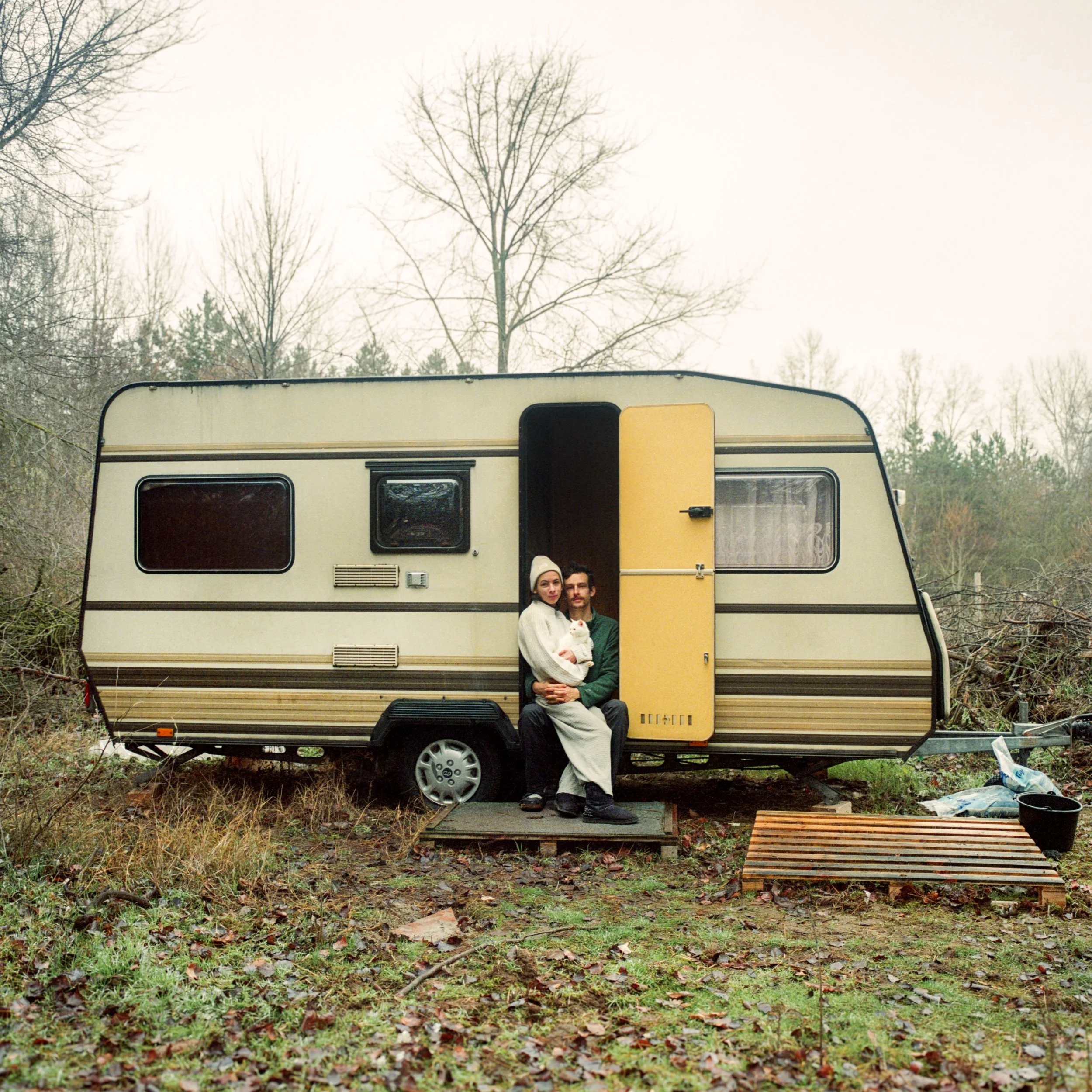 Young couple sitting outside caravan in Hungary