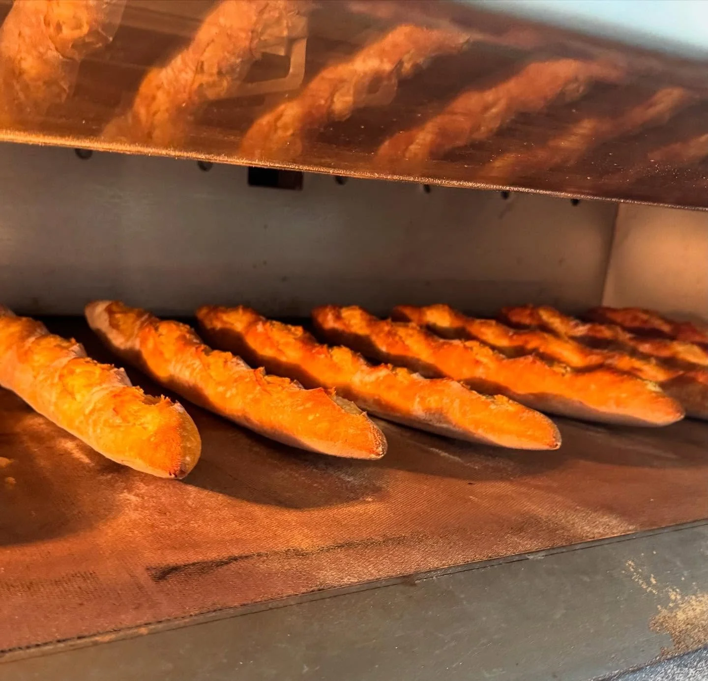 Ancient Grain Sourdough Baguettes baking in our oven at the Modern Stone Age Kitchen. Starting with simple, high quality organic ingredients is not enough. What truly makes these loaves nourishing is the space we provide for the trillions of hyperloc
