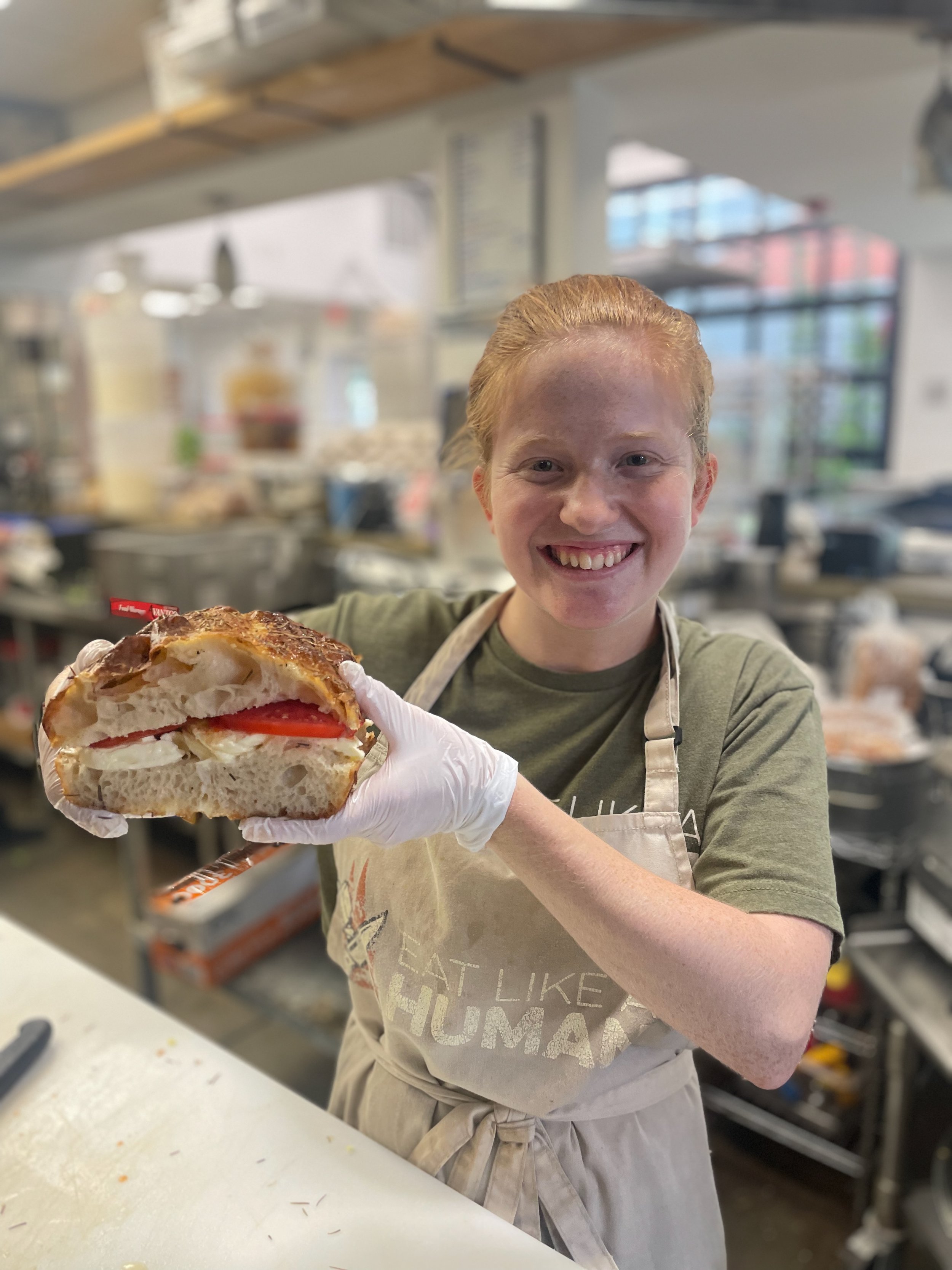 Bri holding a caprese sandwich