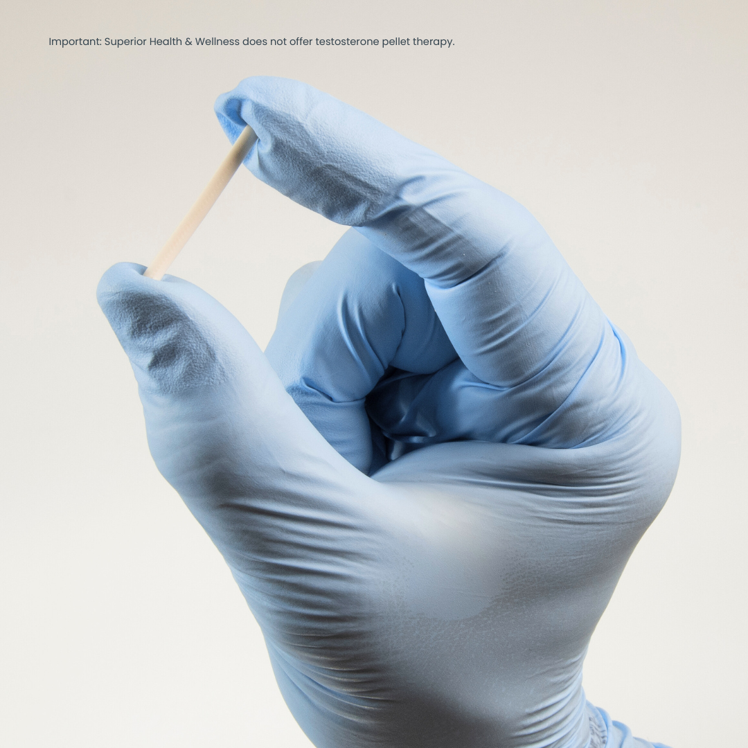 blue gloved hand holding white rod between thumb and pointer finger