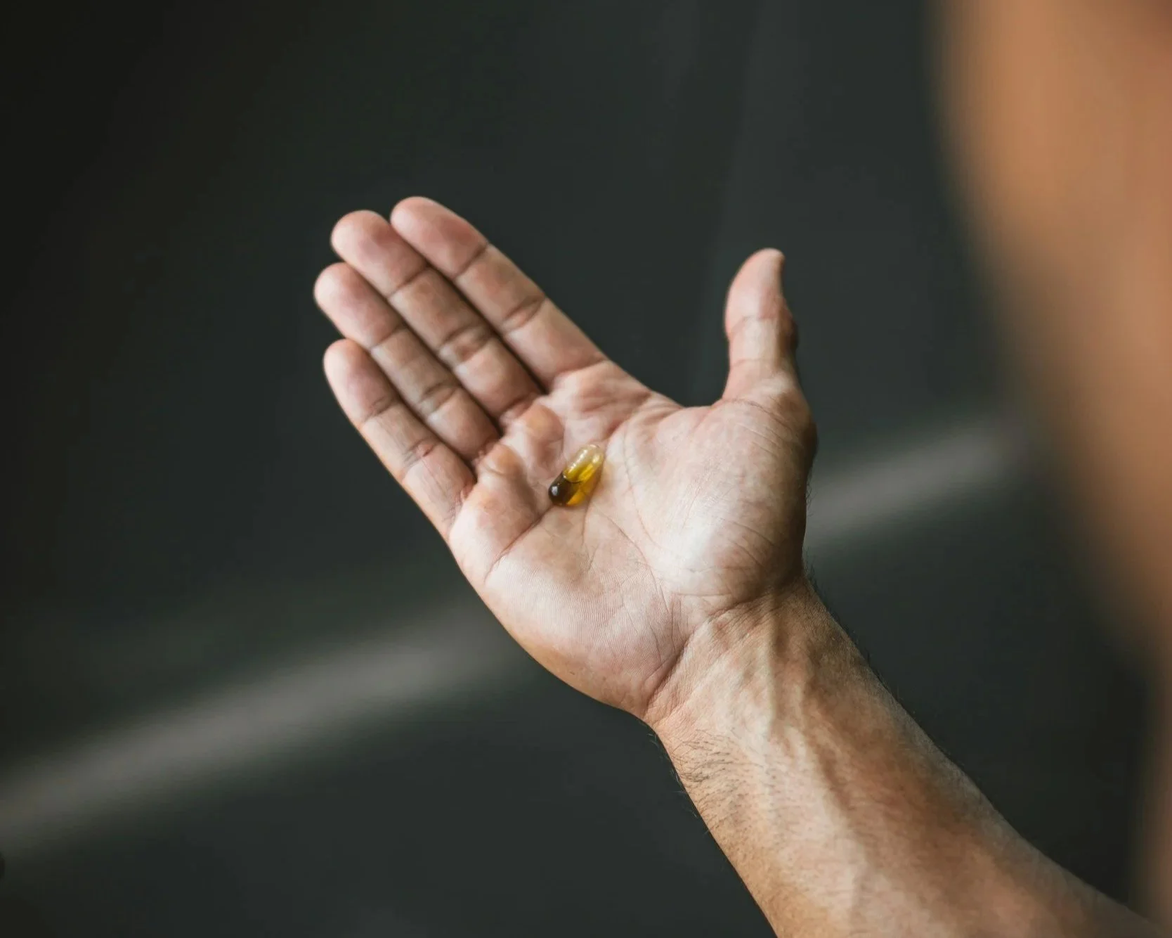 yellow pill open palm hand