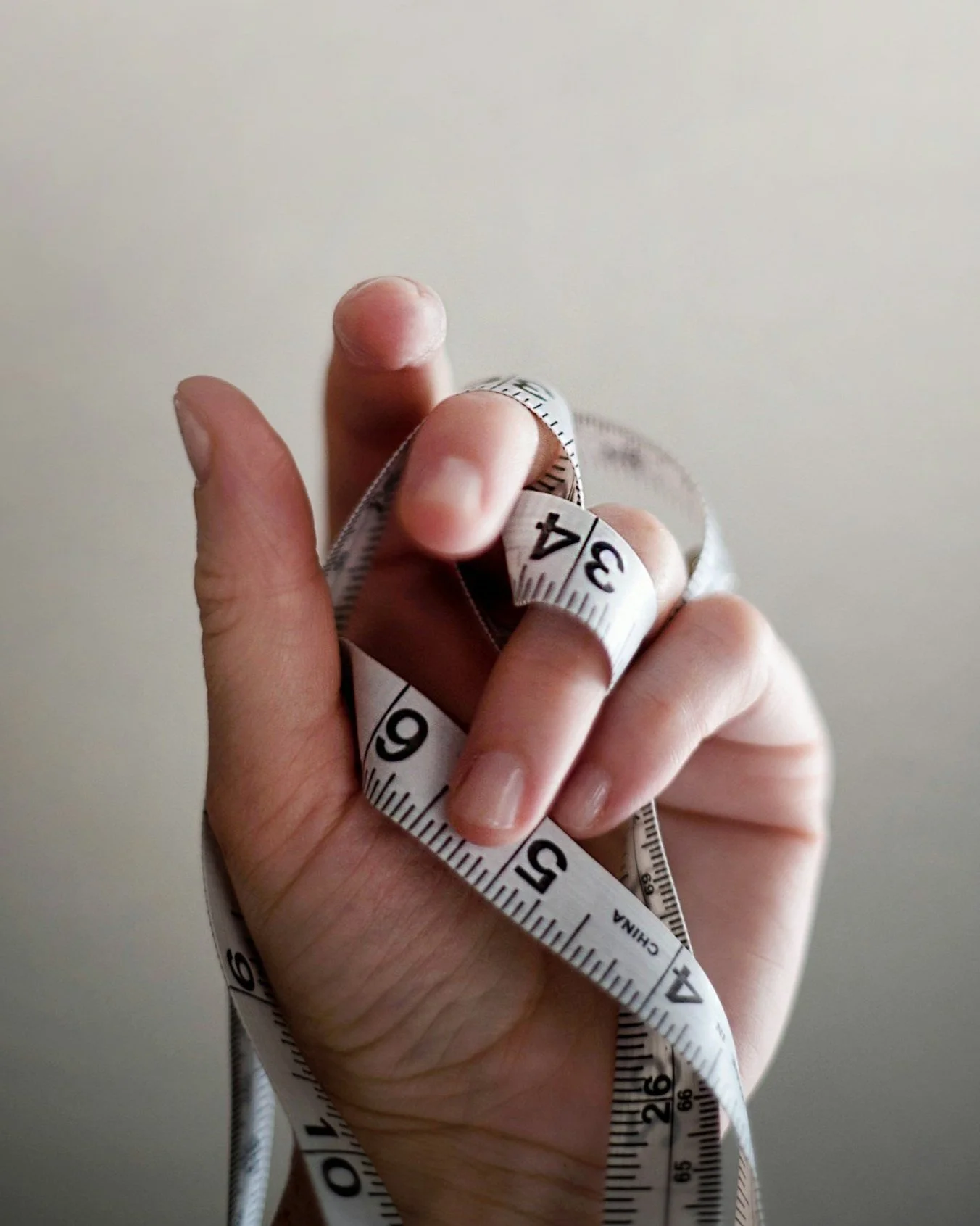 handing holding white measuring tape