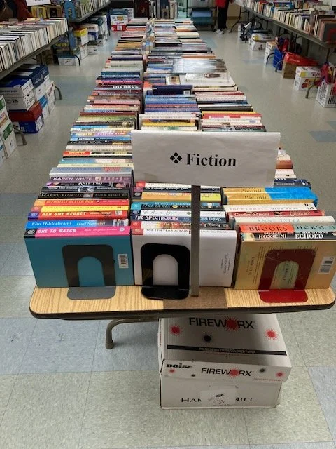 books in category fiction organized on table