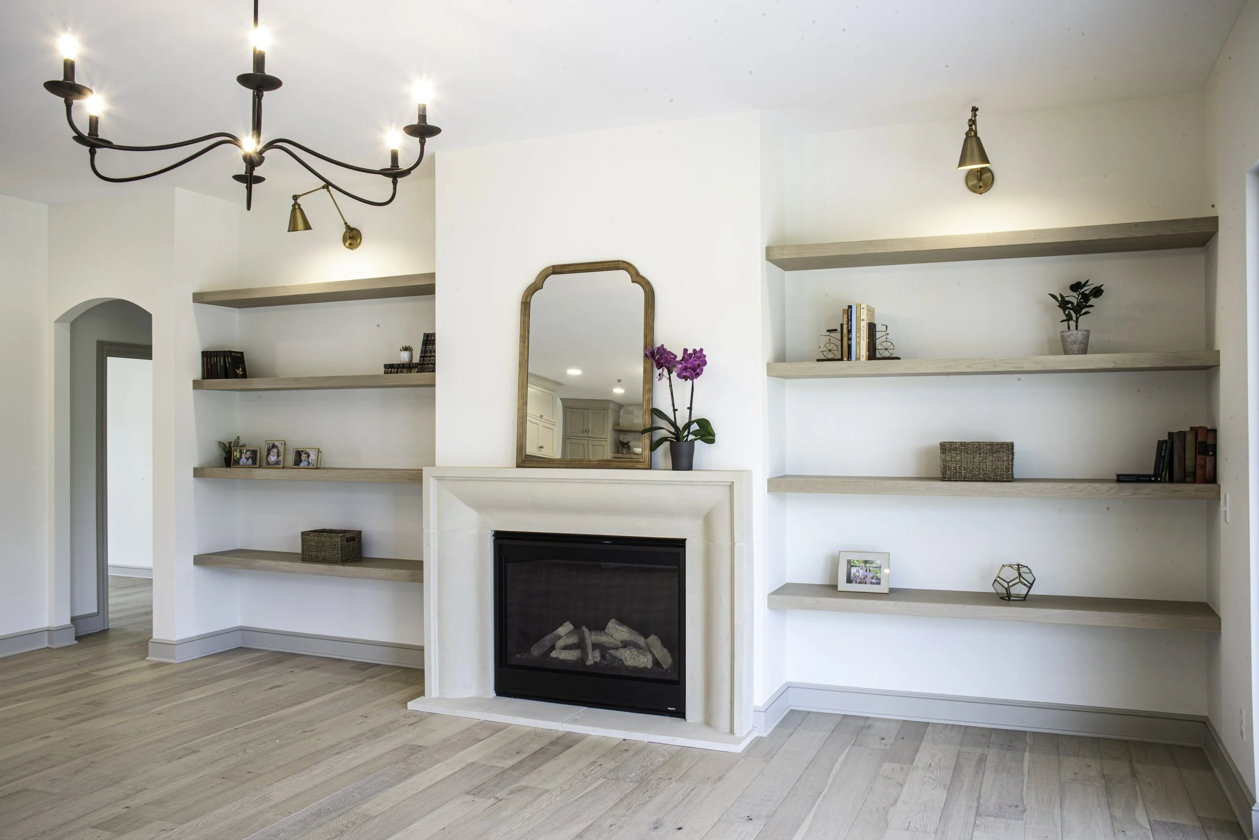 Modern living room lighting idea combining chandelier and wall-mounted lights.